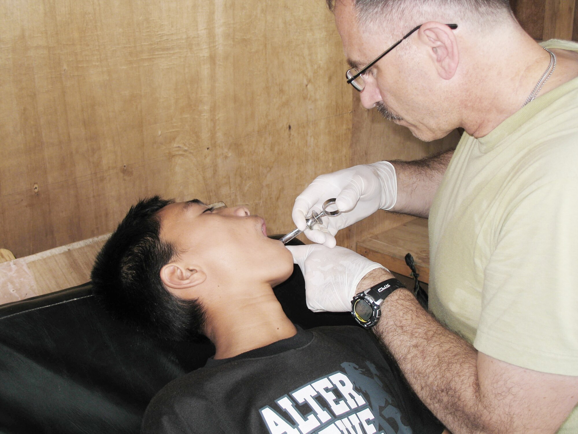 Maj. Joseph Bartle administers a dental anesthesia block to a patient receiving dental care Nov. 15, 2009, at Jolo, Philippines. Major Bartle is an orthopedic physician assistant assigned to Joint Special Operations Task Force-Philippines Forward surgical team. (U.S. Air Force photo)
