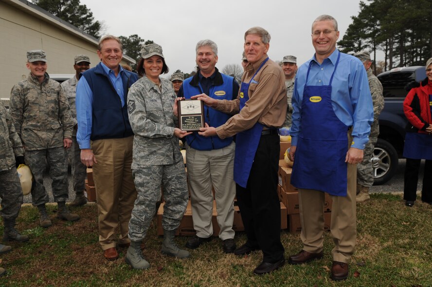 Master Sgt. Shannon Payne, 4th Logistics Readiness Squadron first sergeant, presents North Carolina Butterball corporate leaders a plaque in appreciation for their donation of 200 turkeys to Seymour Johnson Air Force Base, N.C., Dec. 18, 2009. The turkeys were included in holiday food baskets given out by the First Sergeants' Council to Airmen and families who would benefit most from a free holiday meal. (U.S. Air Force photo/Staff Sgt. Courtney Richardson)