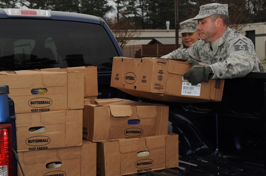Master Sgt. Matthew Stathakis, 4th Aircraft Maintenance Squadron first sergeant, unloads Butterball turkeys on Seymour Johnson Air Force Base, N.C., Dec. 18, 2009. The Butterball headquarters in Garner, N.C., donated 200 turkeys to the Seymour Johnson's First Sergeants Council in support of Airmen and families holiday food baskets. (U.S. Air Force photo/Staff Sgt. Courtney Richardson)