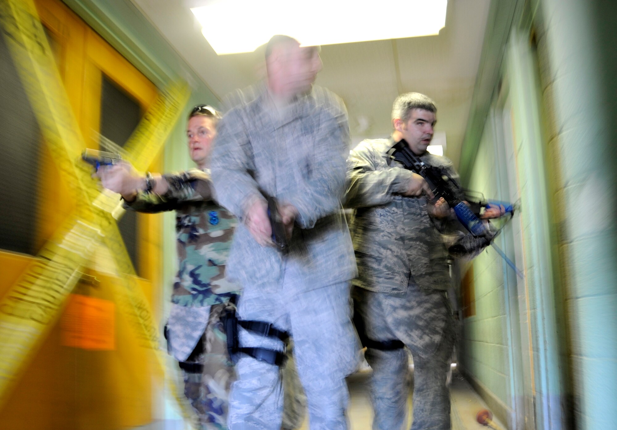 HOLLOMAN AIR FORCE BASE, N.M. -- Airman 1st Class Cory Smith, 49th Security Forces Squadron, leads the way during a building-clearing exercise with Maj. Chris DeGuelle, 49th SFS commander, and Staff Sgt. Matthew Bowker, 49th SFS, Dec. 17. The defenders are participating in "First Responder to an Active Gunman" training taught by members of the Roswell Police Department Special Operations Team. (U.S. Air Force photo by Tech. Sgt. Chris Flahive)