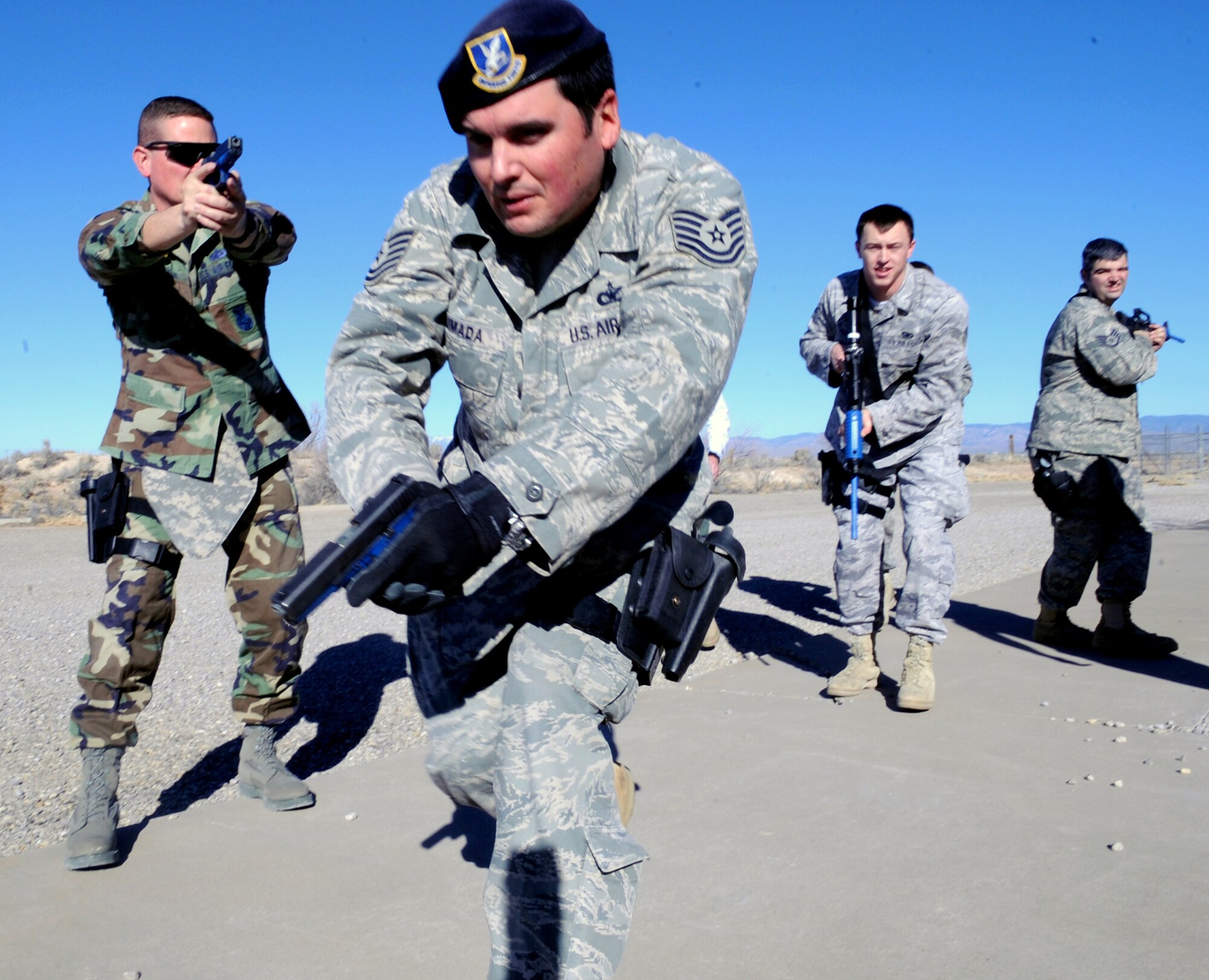 HOLLOMAN AIR FORCE BASE, N.M. -- Members of the 49th Security Forces Squadron practice clearing a building with narrow hallways before moving into an actual building to train Dec. 17. The defenders were participating in "First Responder to an Active Gunman" training taught by members of the Roswell Police Department Special Operations Team. In three days, more than 30 Security Forces members attended the day-long training where they practiced how to enter and clear a room and building -- all while working in groups or "formations" to ensure fire superiority in any situation.  (U.S. Air Force photo by Airman 1st Class Sondra Escutia)