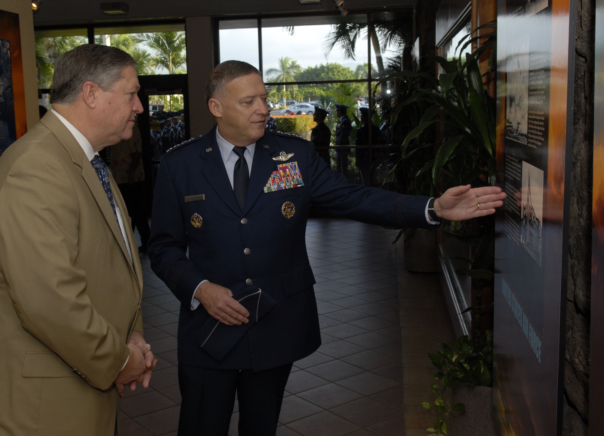 HICKAM AIR FORCE BASE, Hawaii ? General Gary North, Pacific Air Forces commander, shows the Honorable Michael Donley, Secretary of the Air Force, displays posted at the Courtyard of Heroes at Pacific Air Forces Command Headquarters here, Dec. 18. Hickam Air Force Base is his first stop of his tour of air bases in PACAF. PACAF is responsible for Air Force activities spread over half the globe in a command that supports 45,000 Air Force people serving principally in Hawaii, Alaska, Guam, Korea, and Japan. (U.S. Air Force photo/Tech. Sgt. Jerome Tayborn)
