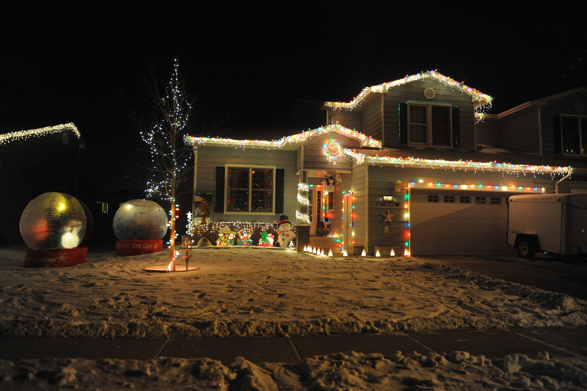 MINOT AIR FORCE BASE, N.D. -- A house stands illuminated with holiday cheer in base housing here Dec. 21. Many people on base celebrate the holiday season by decorating their houses and lawns in lights. Base residents don't let the weather conditions stop them from celebrating the holidays in style. (U.S. Air force photo by: Staff Sgt. Stacy Moless)