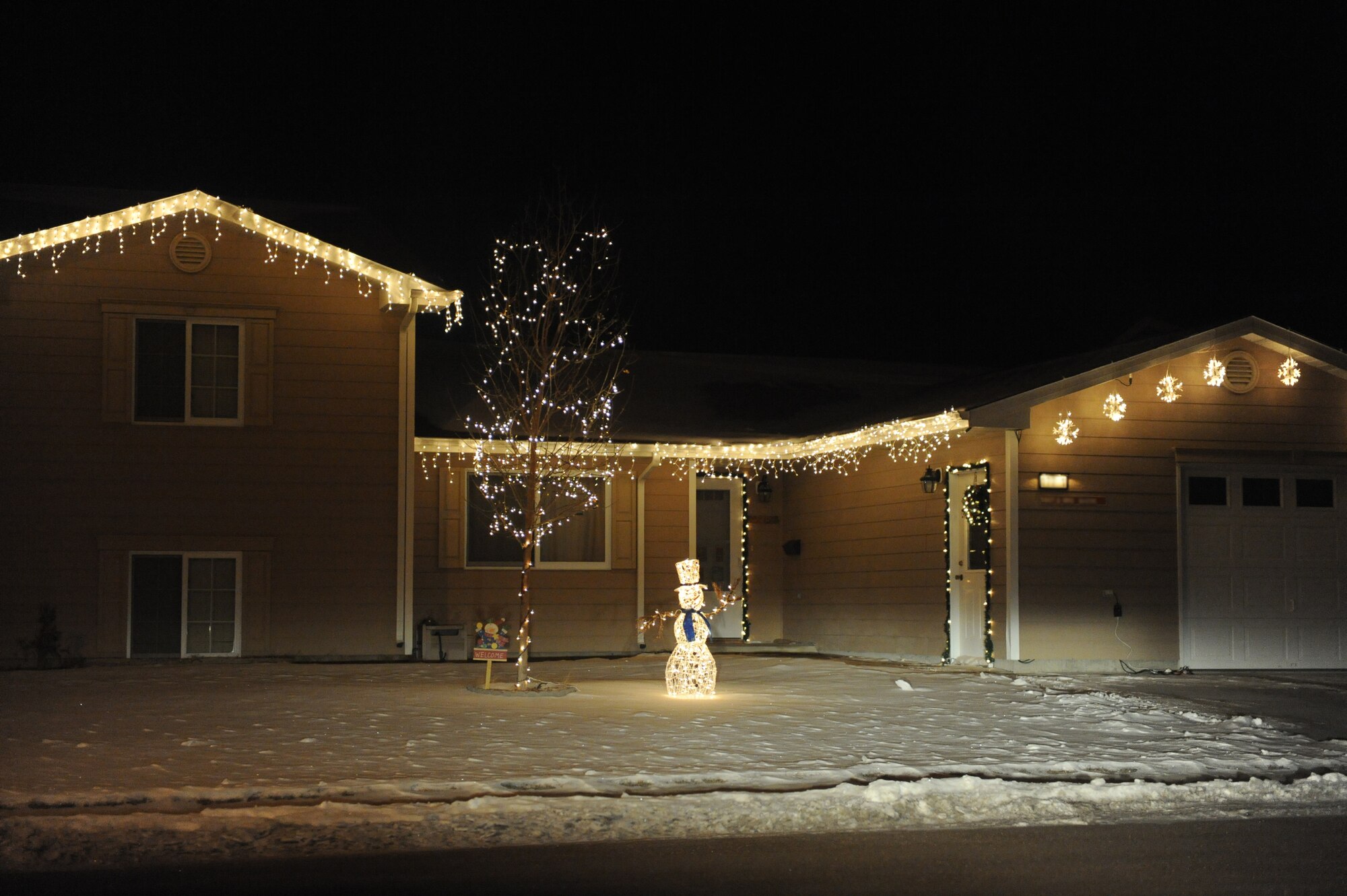 MINOT AIR FORCE BASE, N.D. -- A house stands illuminated with holiday cheer in base housing here Dec. 21. Many people on base celebrate the holiday season by decorating their houses and lawns in lights. Base residents don't let the weather conditions stop them from celebrating the holidays in style. (U.S. Air force photo by: Staff Sgt. Stacy Moless)