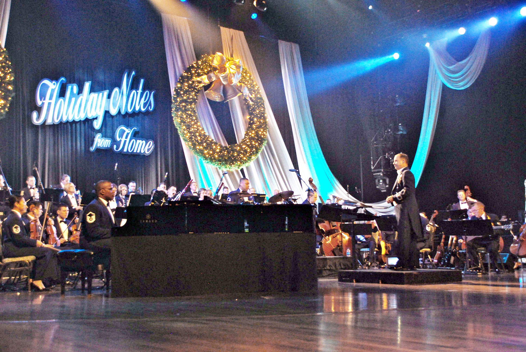 Maj. Donald Schofield leads the 60-member orchestra during the 2009 Holiday Notes from Home taped concert Oct. 26, 2009, at the Grand Ole Opry House in Nashville, Tenn. The annual holiday concert, featuring Amy Grant, Brian McKnight, Take 6, Band of the Air Force Reserve and Air Force Strings ensemble, will broadcast on Gospel Music Channel and American Forces Network. Major Schofield is the Band of the Air Force Reserve commander. (U.S. Air Force/Ken Hackman)