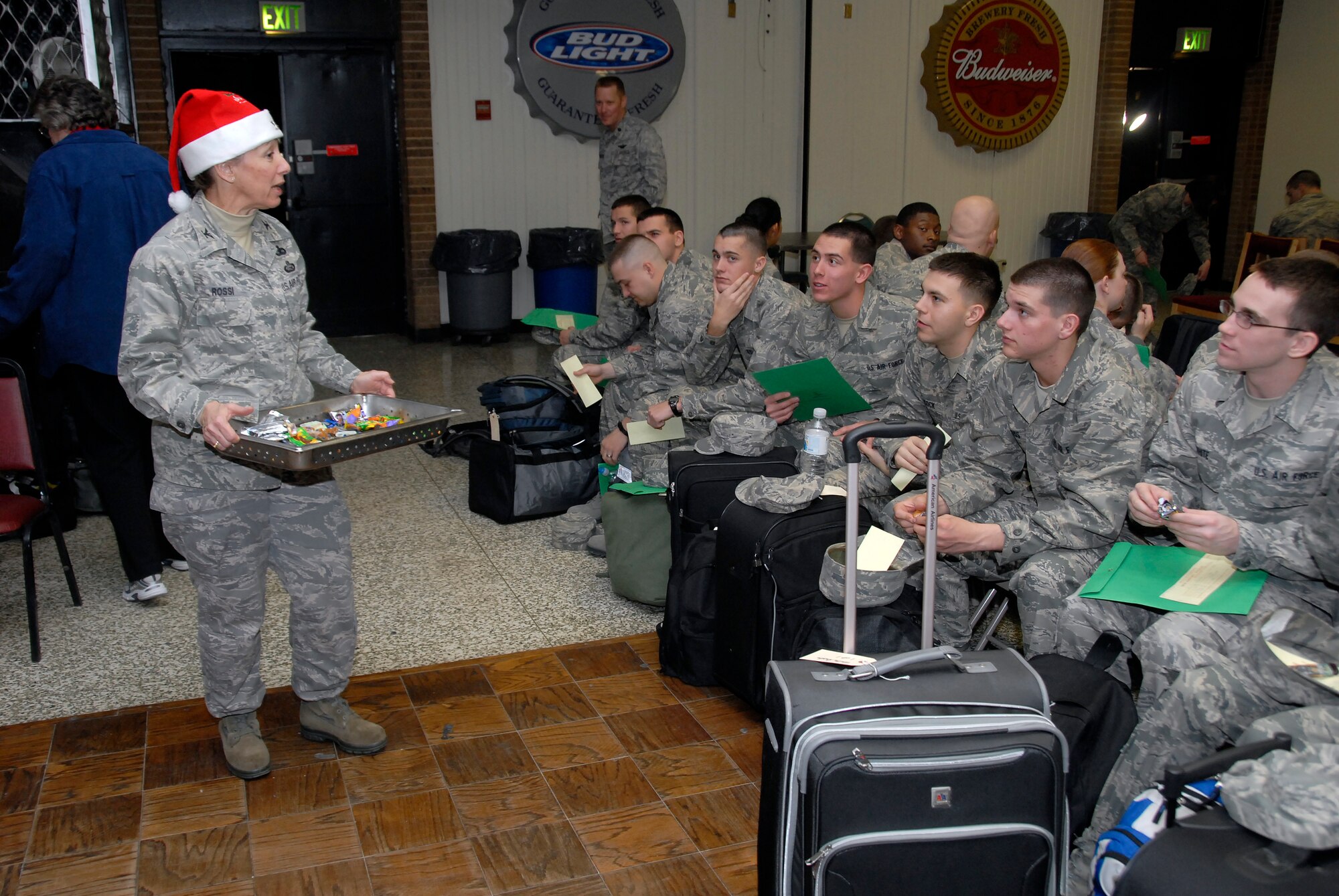 Col. Marcia Rossi, 82nd Training Wing director of staff, hands out refreshments to Airmen in Training awaiting their bus departure for Exodus Dec. 19 at the Airman’s Club. More than 4,500 Airmen deployed home for the holidays this year. (U.S. Air Force photo/Mike Litteken)