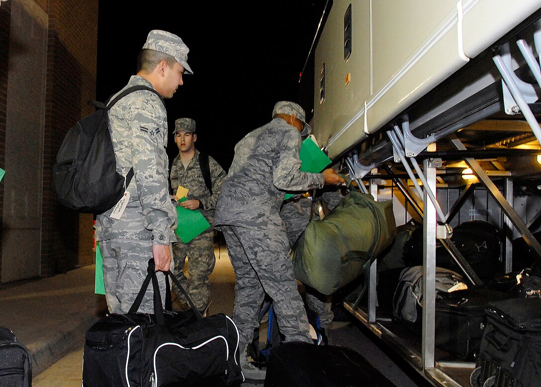 Airmen in Training load their luggage onto the shuttle bus Dec. 19 to begin Exodus at the Airman’s Club. More than 4,500 Airmen deployed home for the holidays this year. (U.S. Air Force photo/Mike Litteken)
