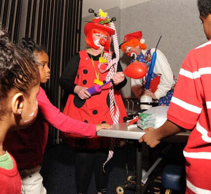 Volunteer clowns, Lady Bug Lola and Troubles, make different balloon animals for children, Dec. 12, 2009, during Santa’s visit at the Robert J. Dole Center at McConnell Air Force Base, Kan.  (U.S. Air Force Photo/Airman 1st Class Ruiz) 