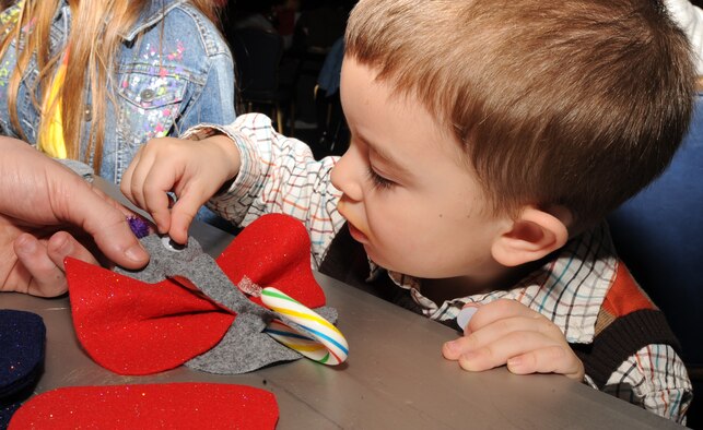 Team McConnell family member Landon Lane makes a candy cane mouse, Dec. 12, 2009, during Santa’s visit at the Robert J. Dole Center at McConnell Air Force Base, Kan.  (U.S. Air Force Photo/Airman 1st Class Ruiz) 