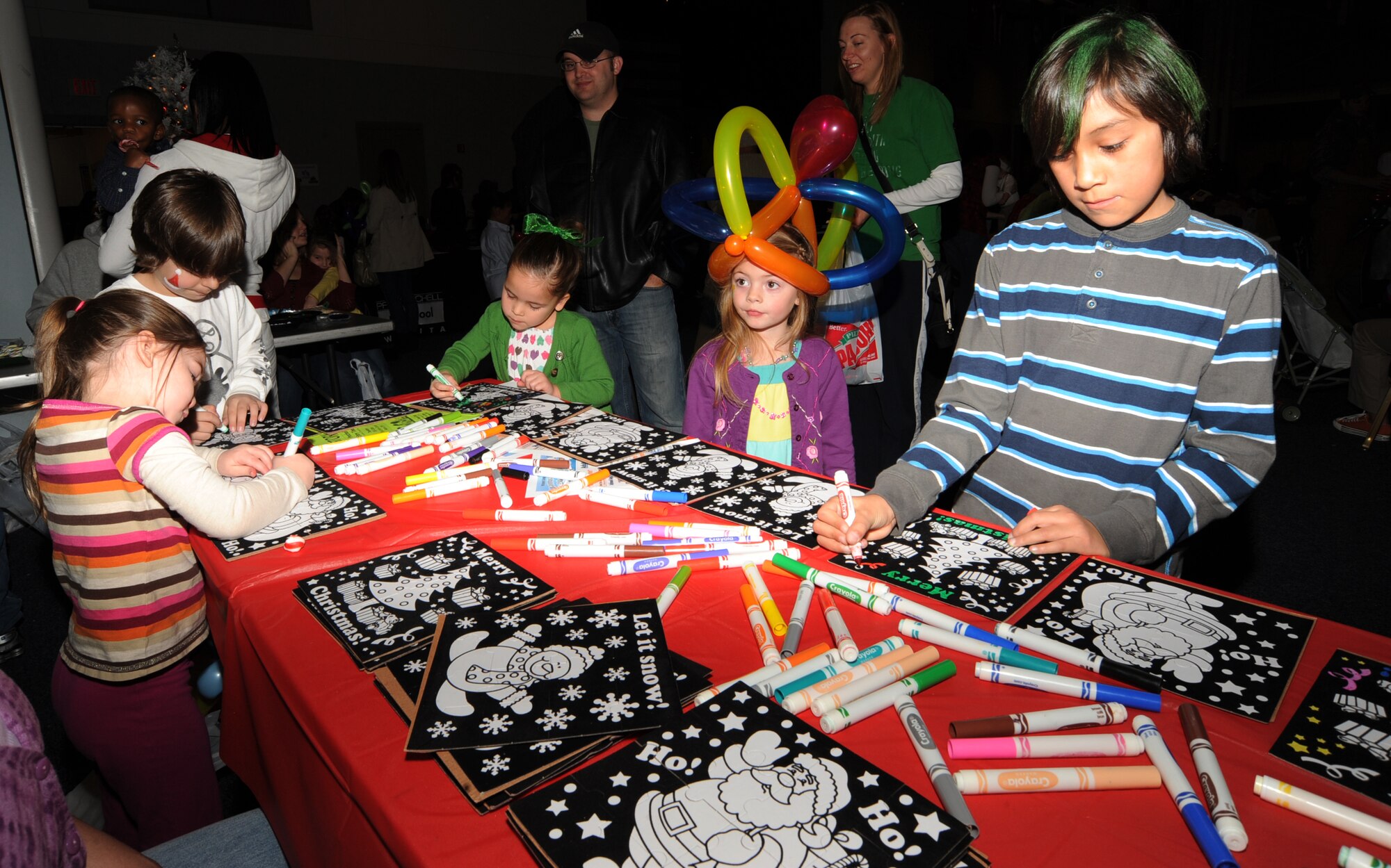 Team McConnell children color holiday puzzles, Dec. 12, 2009, during a Santa visit at the Robert J. Dole Center The holiday event features seasonal music and games for more than 650 family members who attended.  (U.S. Air Force Photo/Airman 1st Class Ruiz) 