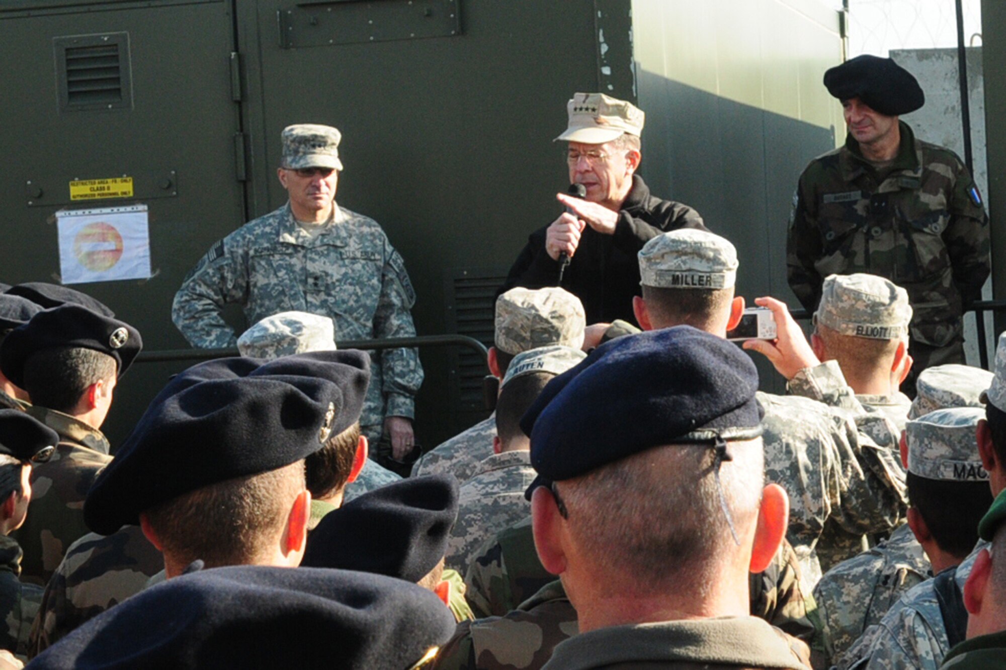 Navy Adm. Michael Mullen addresses a crowd of coalition servicemembers Dec. 16, 2009, at Forward Operating Base Morales-Frazier, Afghanistan. Admiral Mullen met with French Brig. Gen. Marcel Druart to learn more about coalition efforts in Nijrab, Afghanistan and other nearby areas. It was the first meeting between the two since Task Force Lafayette's' assumption of command in November 2009. Admiral Mullen is the chairman of the Joint Chiefs of Staff. General Druart is the commander of Task Force La Fayette. (U.S. Air Force photo/Capt. Darrick B. Lee)
