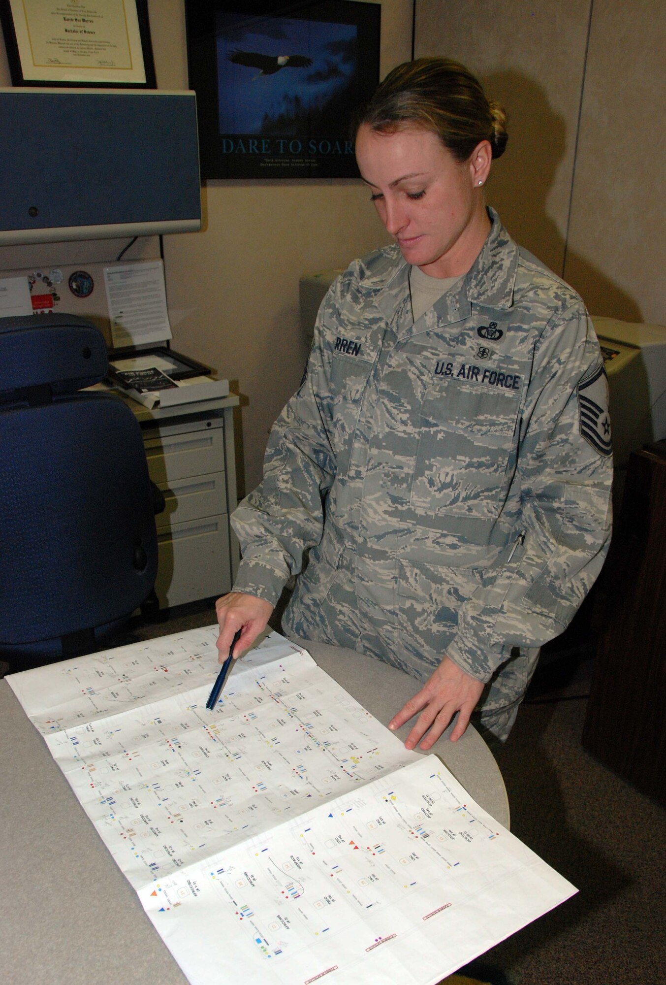 Master Sgt. Karrie Warren, 601st Air and Space Operations Center noncommissioned officer in charge of requirements and security, reviews a plan for the operations floor. Sergeant Warren was awarded the 2009 U.S. Air Force Female Athlete of the Year.  (U.S. Air Force Photo by Maj. Steve Burke)