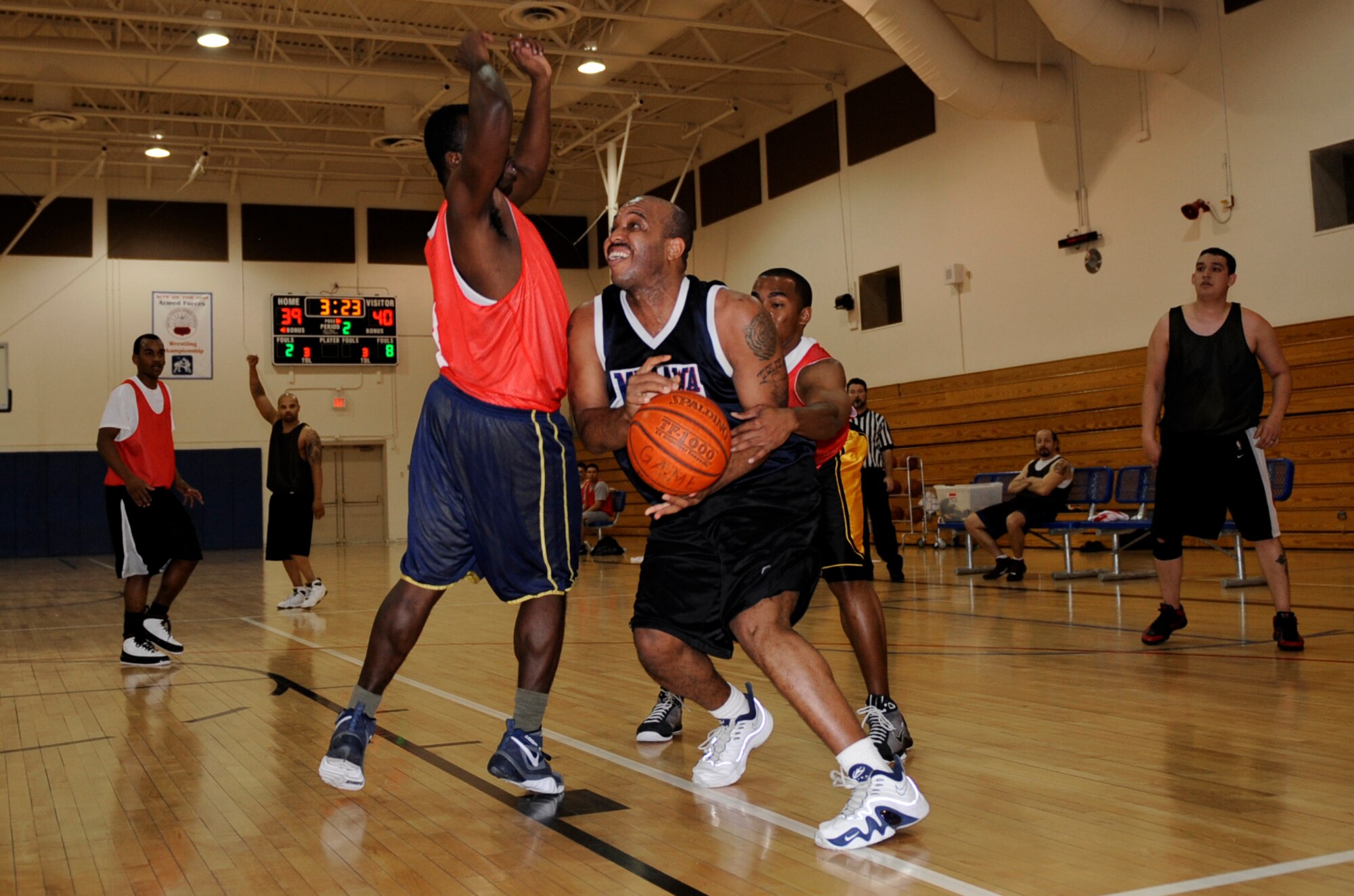 MOUNTAIN HOME AIR FORCE BASE, Idaho -- Mark Fox, 366th Security Forces Squadron center, gets fouled by two 366th Component Maintenance Squadron defenders during an intramural basketball game Dec 15. CMS upset an undefeated SFS 46-45. (U.S. Air Force photo by Airman 1st Class Renishia Richardson)