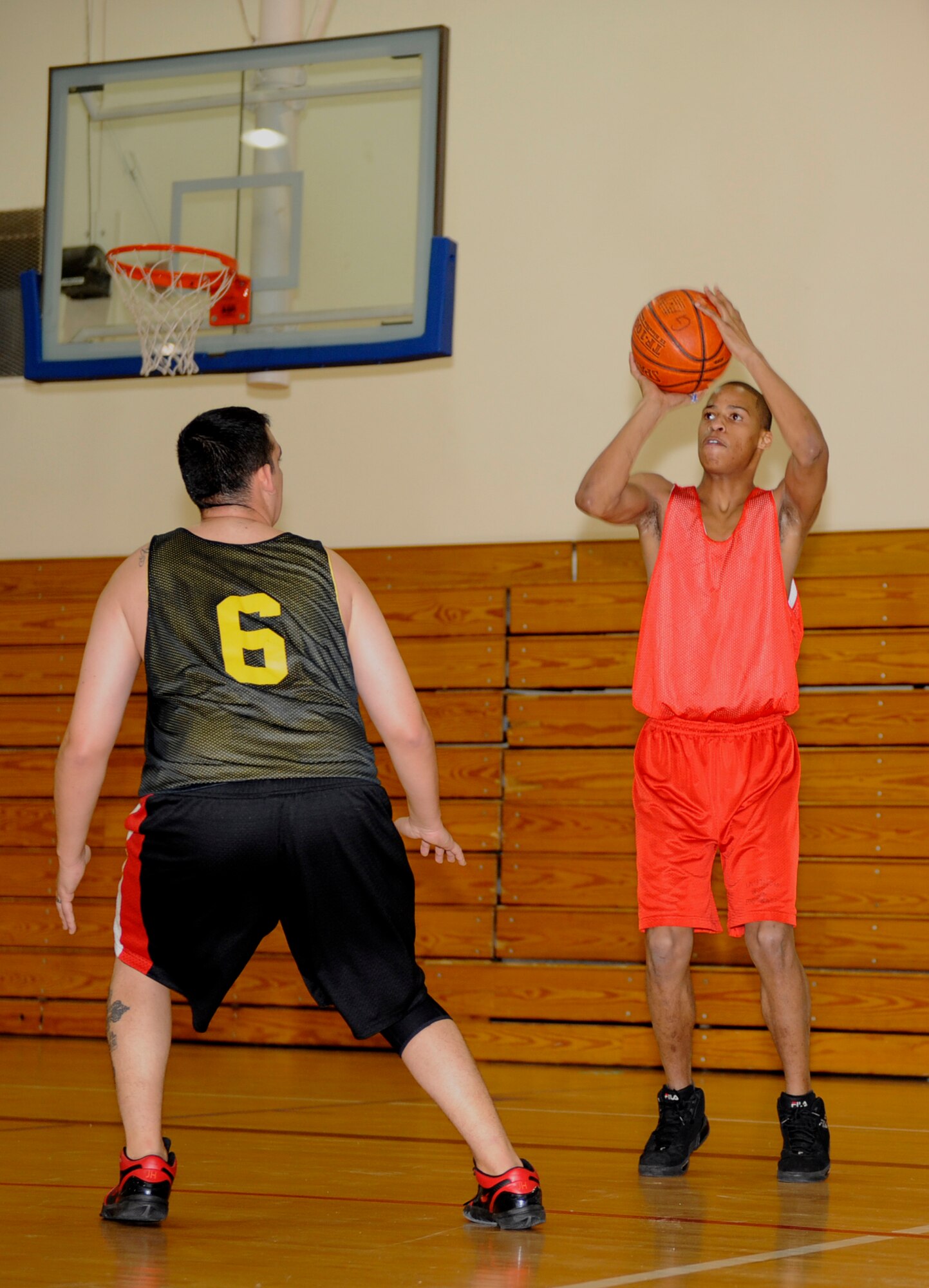 MOUNTAIN HOME AIR FORCE BASE, Idaho -- Tieron Riley, 366th Component Maintenance Squadron shooting guard, takes a shot over a defender from the 366th Security Forces Squadron during an intramural basketball game Dec. 15. CMS upset an undefeated SFS 46-45. (U.S. Air Force photo by Airman 1st Class Renishia Richardson)