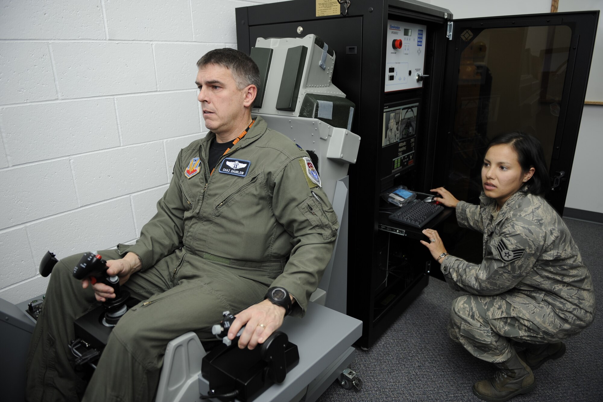 MOUNTAIN HOME AIR FORCE BASE, Idaho -- Staff Sgt. Maria Paucar, 366th Aerospace Medicine Squadron aerospace and operational physiology technician, resets the first on base sim-based hypoxia demo for Lt. Col. Charles Shurlow, 366th AMS aerospace medicine chief Dec. 16. The simulators help familiarize aircrew with the physiological and psychological stresses of flight. Without the aid of an oxygen mask aircrew experience symptoms of hypoxia, an oxygen deficiency of the tissue and blood cells that causes impairment of function at high altitudes. (U.S. Air Force photo by Airman 1st Class Renishia Richardson)