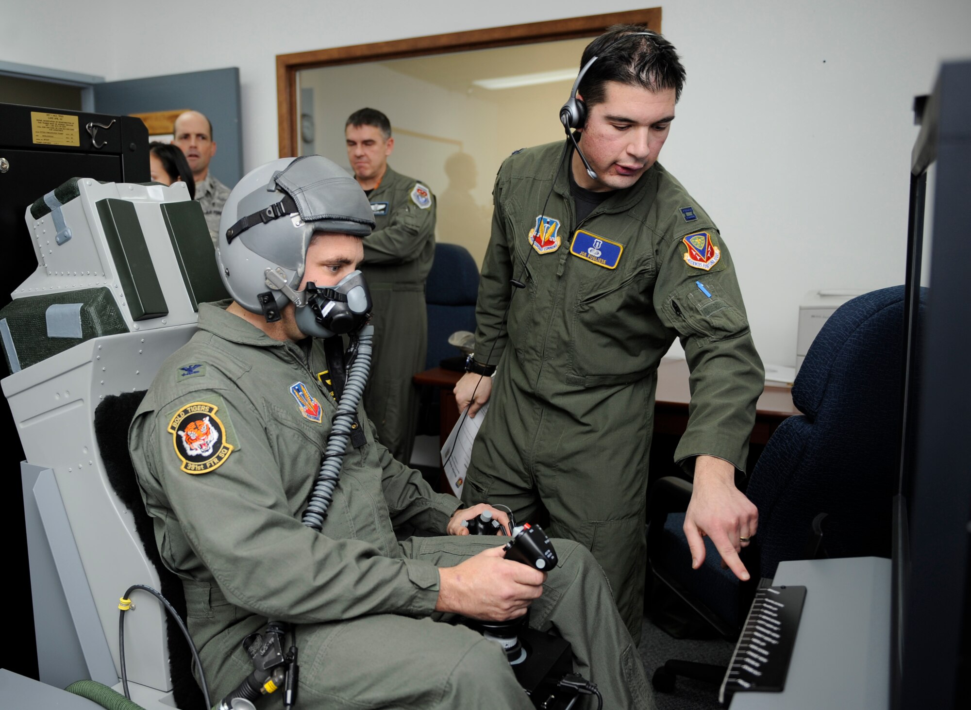 MOUNTAIN HOME AIR FORCE BASE, Idaho -- Capt. Joseph Pugliese, 366th Aerospace Medicine Squadron aerospace and operational physiologist, briefs Col. Kevin Connolly, 366th Medical Group commander, on the first on base sim-based hypoxia demo for fighter aircrew Dec. 16. The simulators help familiarize aircrew with the physiological and psychological stresses of flight. Without the aid of an oxygen mask aircrew experience symptoms of hypoxia, an oxygen deficiency of the tissue and blood cells that causes impairment of function at high altitudes. (U.S. Air Force photo by Airman 1st Class Renishia Richardson)