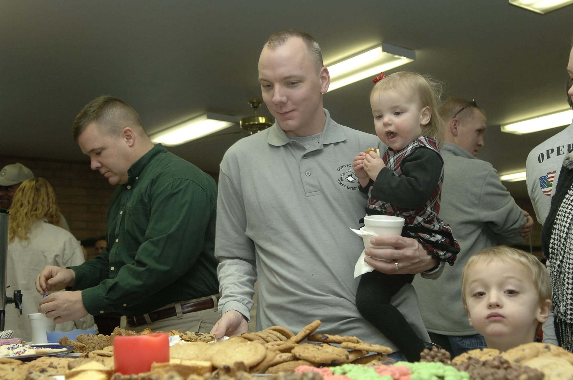 MOUNTAIN HOME AIR FORCE BASE, Idaho --Master Sgt. Michael Vonahnen, 366th Aircraft Maintenance Squadron first sergeant, gets cookies for his children during the Silver Crest II Annual Holiday Social in Nampa, Idaho, Dec. 12. Two members of the retirement community, Rita and Bud Albers, have put together this event for nine years. This year more than $13,000, hundreds of toys and quilts, and 2,000 pounds of food were donated to Operation Warmheart to help military families during the holiday season. (U.S. Air Force photo by Staff Sgt. Jasmine Reif)