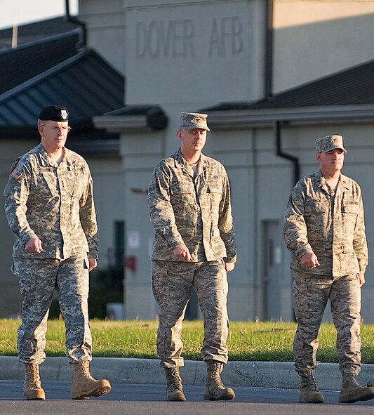 Chaplain (Maj.) Richard Bach (right) prepares for a dignified transfer as part of the official party. Chaplain Bach is a National Guardsman deployed to the Air Force Mortuary Affairs Operations Center at Dover Air Force Base, Del.  (U.S. Air Force photo/Roland Balik)