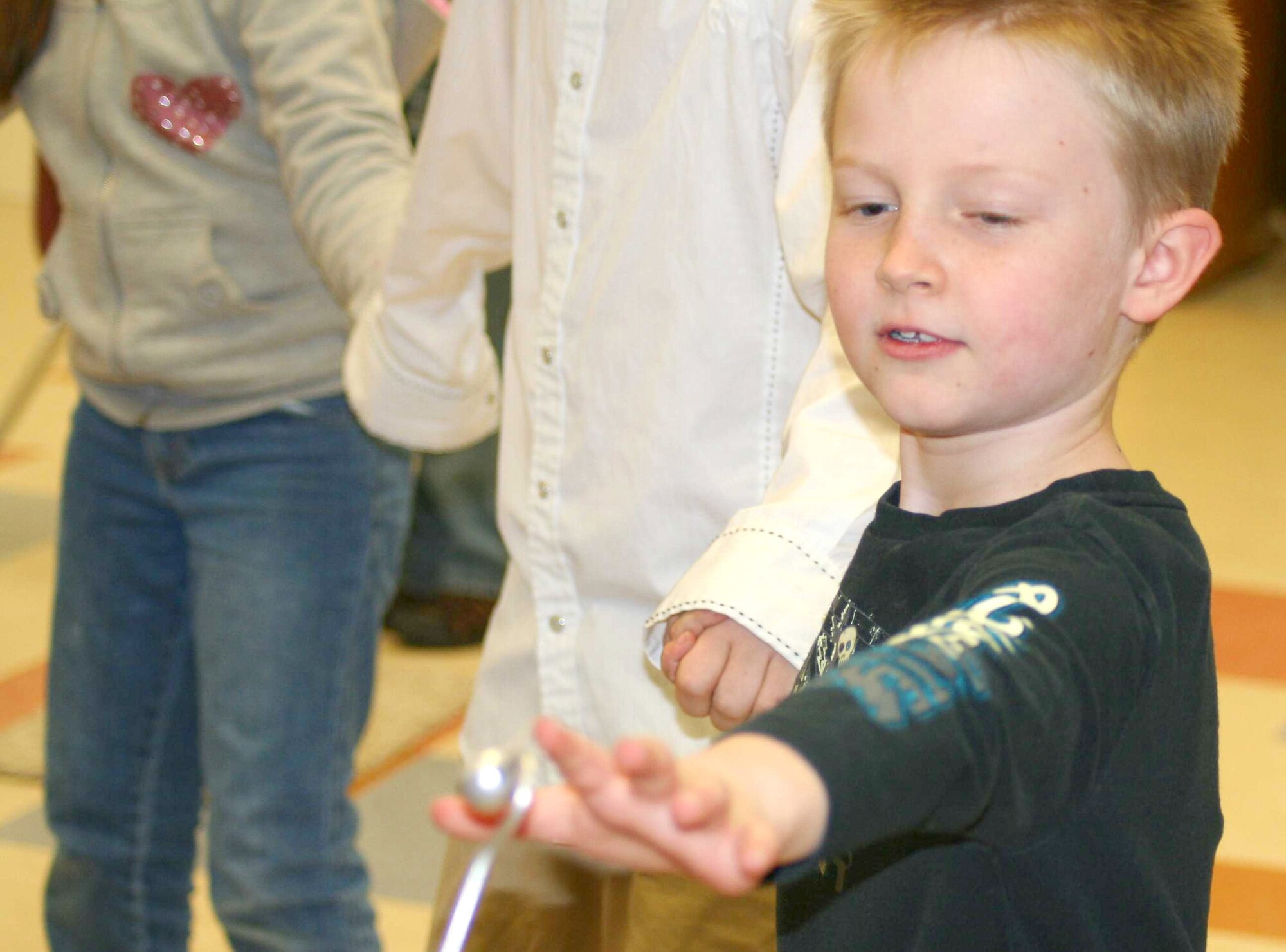West Elementary School third grader Annione Platten reaches to close a human circuit at a recent "Physics is Phun" event sponsored by the Air Force Academy Dec. 11, 2009. "Physics is Phun" is an education outreach program run by the Academy's Physics Department to show children how fun physics, science, and mathematics can be. (U.S. Air Force photo courtesy of Julie Imada)