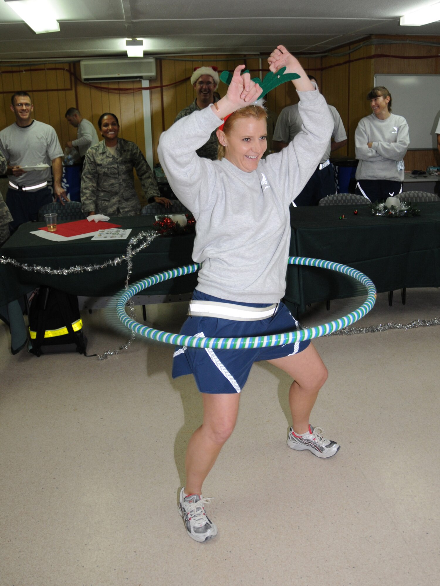 Tech. Sgt. Sarah Fry, 379th Expeditionary Medical Group ophthalmic craftsman, hula hoops at the Medical Group holiday celebration in a deployed location in Southwest Asia, Dec. 19, 2009. Members of the 379th Expeditionary Medical Group took time out to enjoy food and fellowship while deployed away from family members back home. Sergeant Fry is deployed from the Wyoming Air National Guard in support of operations Iraqi Freedom and Enduring Freedom.
(U.S. Air Force Photo/Tech. Sgt. Jason W. Edwards)