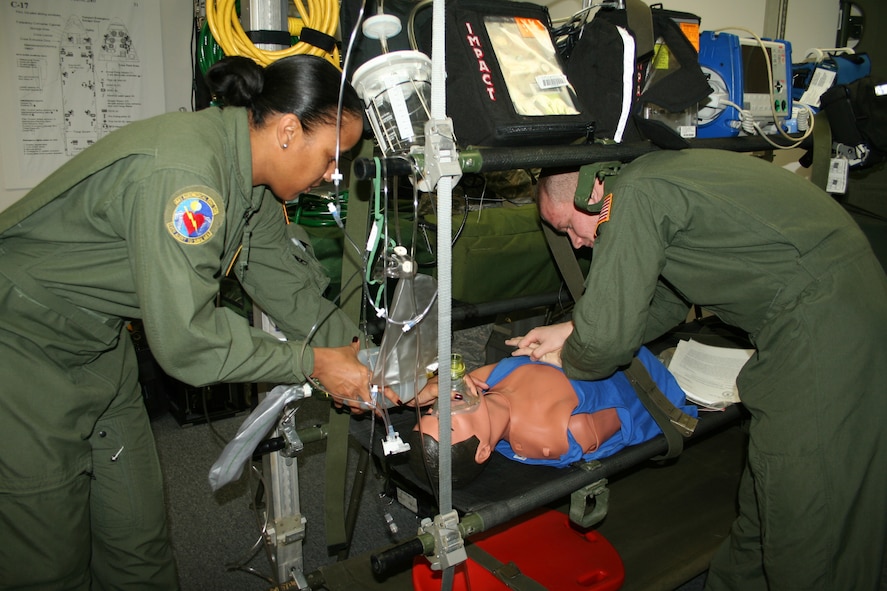 Senior Airman Jacob McCorkle, 445th Aeromedical Evacuation Squadron, and Tech. Sgt. Sonya Kidd practice their CPR skills on a simulated patient during training Nov. 15. AES Airmen care for the sick and wounded during flight. AES transported more than 12,000 patients in 2009 (U. S. Air Force photo/Senior Airman Matthew Cook)