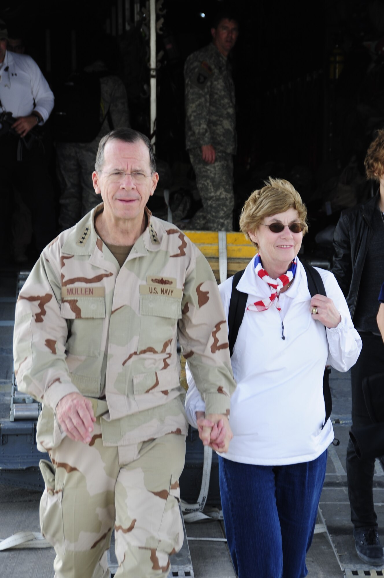 ALI BASE, Iraq - Adm. Mike Mullen, Chairman of the Joint Chiefs of Staff, and Mrs. Deborah Mullen exit a US Air Force C-130 aircraft here December 18th during his tour of military installations throughout Southwest Asia. Adm. Mullen held a press conference with Iraqi and American media to discuss progress in Iraq and the importance of the upcoming elections.  (U.S. Air Force photo/Master Sgt. Darrell Habisch)
