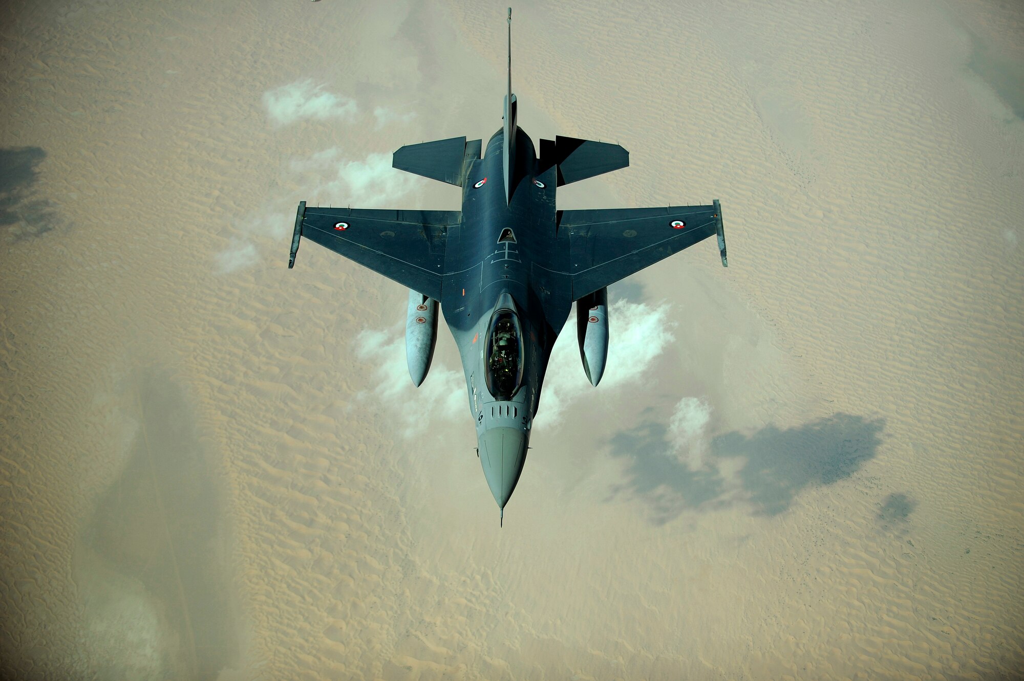 An Emirati F-16 disconnects from a 908th Expeditionary Air Refueling Squadron KC-10A Extender after refueling during a multinational exercise, Dec. 9, 2009.  Aircrews from France, Jordan, Pakistan, the U.A.E., the U.K., and the U.S. trained together in the Air Forces Central area of responsibility in fighting a large-scale air war.  (U.S. Air Force photo by Staff Sgt. Michael B. Keller) (Released)

