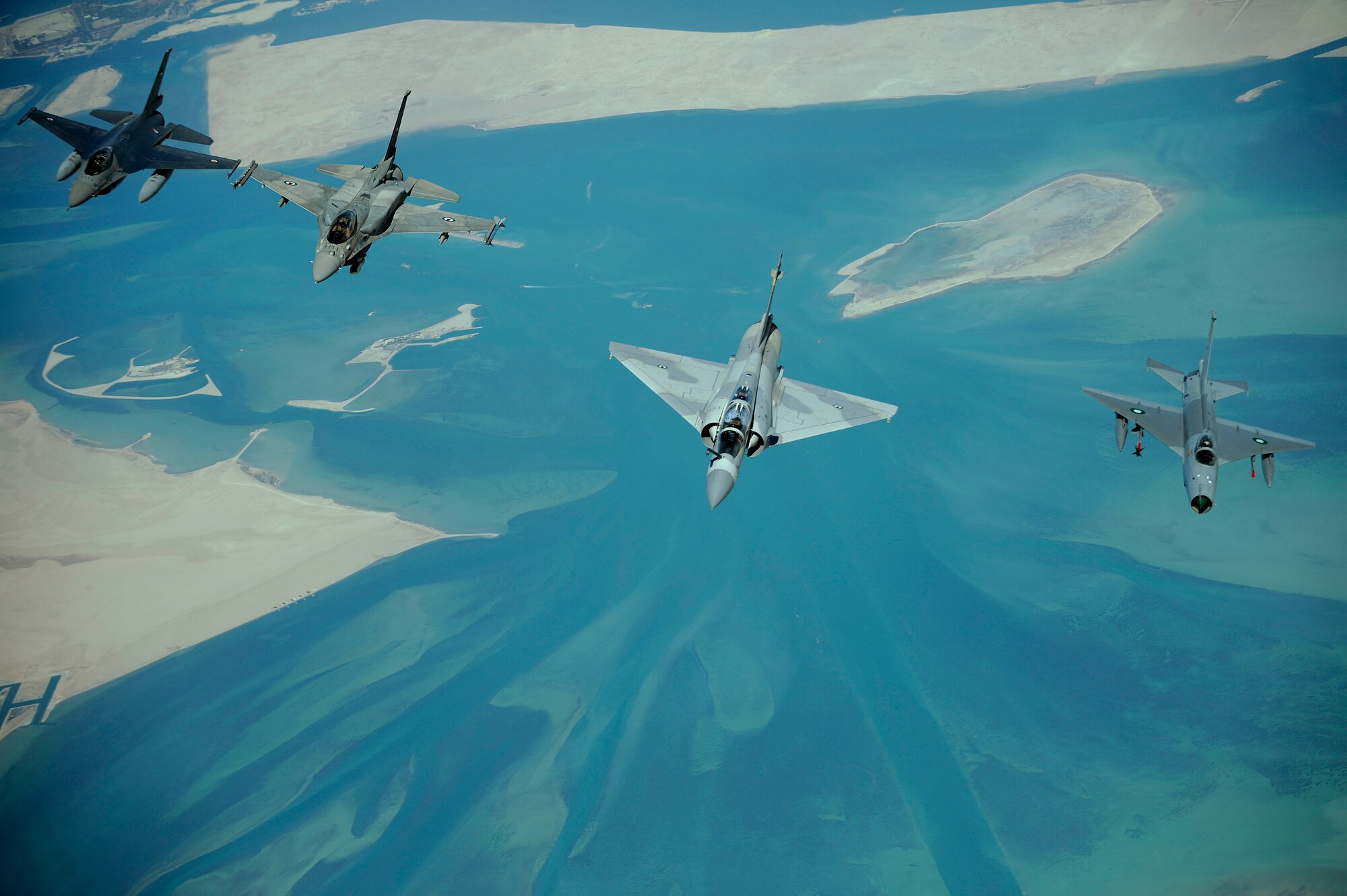 Emirati F-16's, an Emirati Mirage 2000, and a Pakistani F-7, left to right, fly in formation during a multinational exercise, Dec. 9, 2009.  Aircrews from France, Jordan, Pakistan, the U.A.E., the U.K., and the U.S. trained together in the Air Forces Central area of responsibility in fighting a large-scale air war.  (U.S. Air Force photo by Staff Sgt. Michael B. Keller) (Released)


