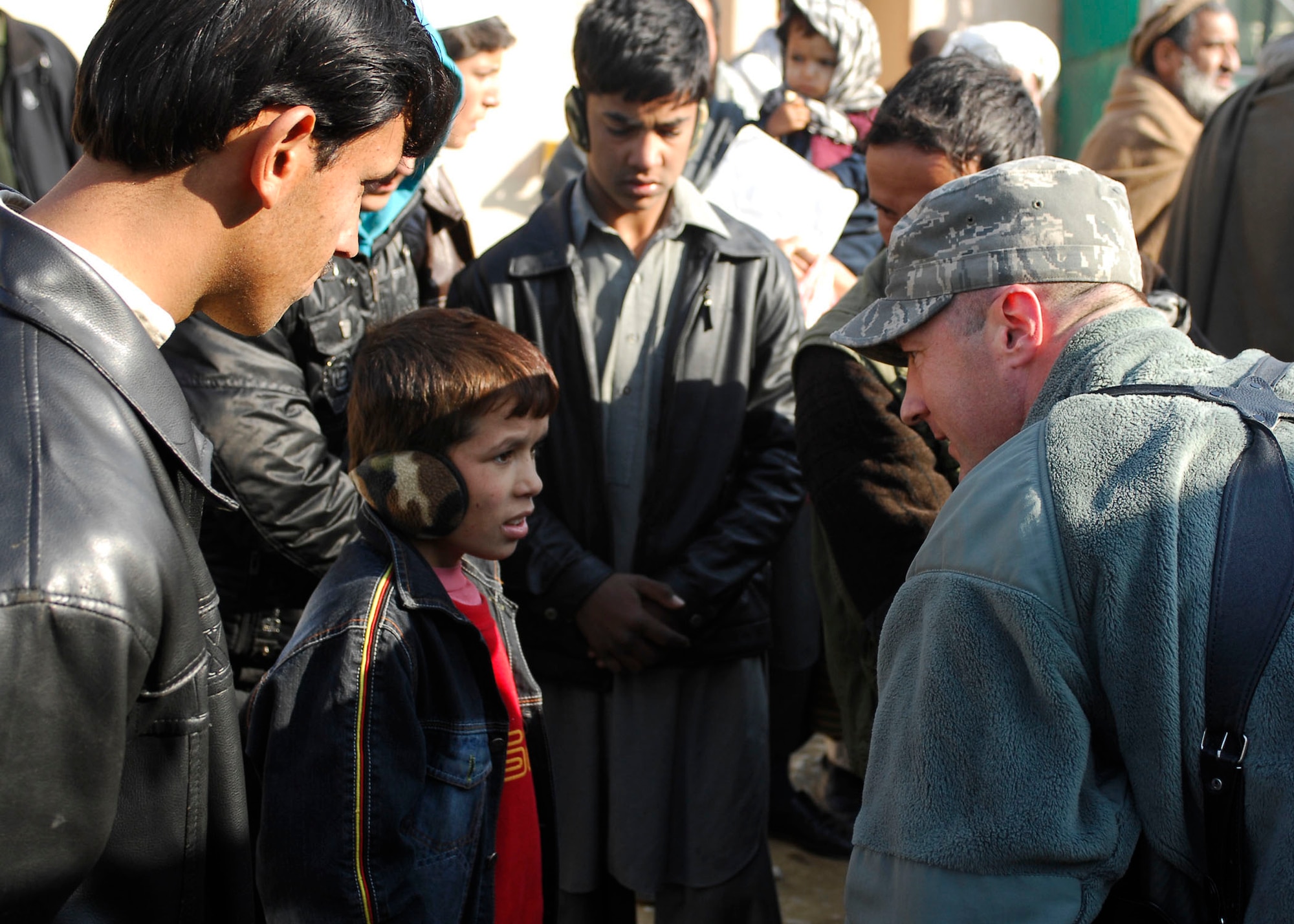 BAGRAM AIRFIELD, Afghanistan -- Major Langdon Root, the executive officer from the 455th Air Expeditionary Wing, gives socks to Afghans during a visit to one of the hospitals on Bagram Airfield, Dec. 21, 2009.  Major Root is deployed from Shaw Air Force Base, S.C., and hails from Vincennes, Ind.  (U.S. Air Force photo/Senior Airman Felicia Juenke)