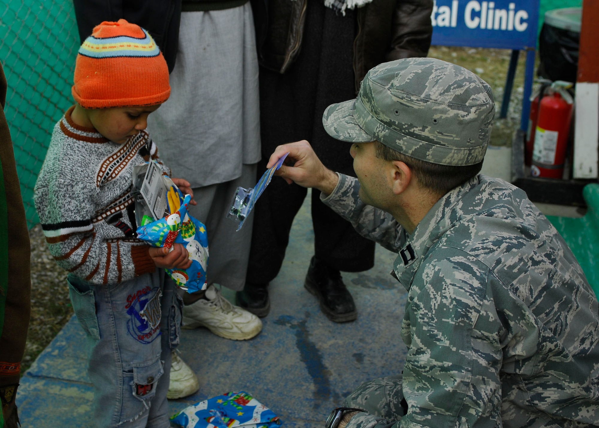 BAGRAM AIRFIELD, Afghanistan -- Captain David Faggard, public affairs officer from the 455th Air Expeditionary Wing, gives toys to Afghan children during a visit to one of the hospitals on Bagram Airfield, Dec. 21, 2009.  Captain Faggard is deployed from the Pentagon and hails from Mobile, Ala.  (U.S. Air Force photo/Senior Airman Felicia Juenke)