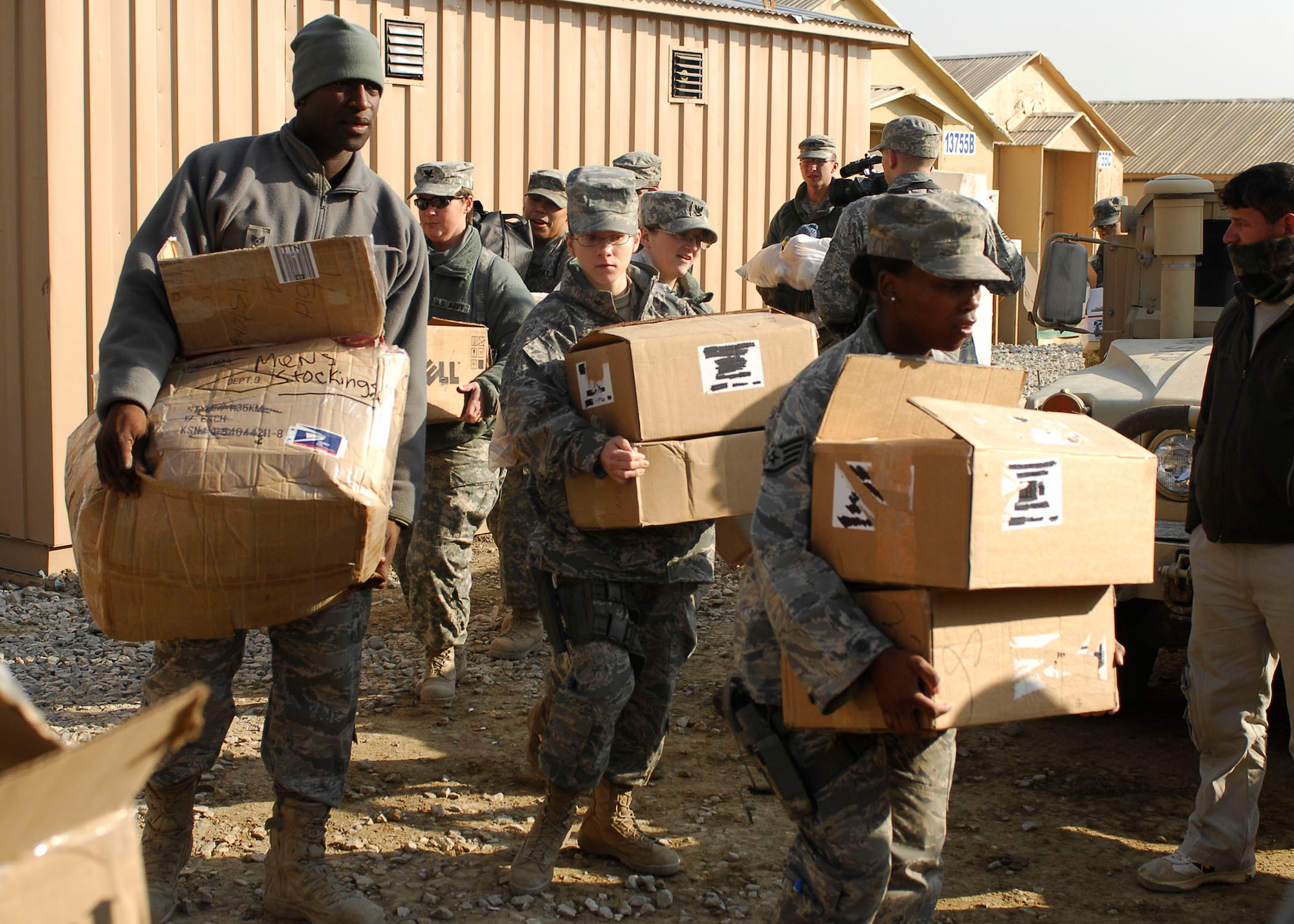 BAGRAM AIRFIELD, Afghanistan -- Airmen, from the 455th Air Expeditionary Wing, deliver boxes of toys, shoes, food, blankets, wool socks and other necessities to local Afghan men and children at one of the hospitals on Bagram Airfield, Dec. 21, 2009.  Airmen, Soldiers and Sailors participated in this humanitarian aid event.  (U.S. Air Force photo/Senior Airman Felicia Juenke)