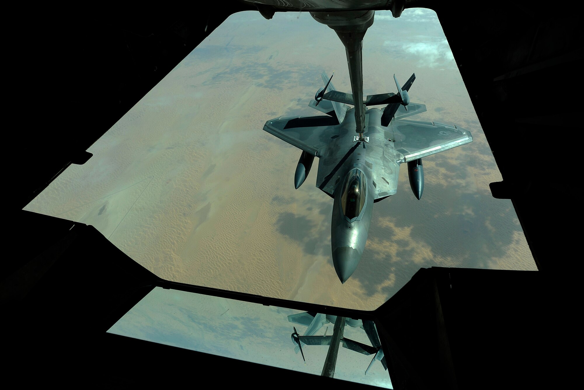 A U.S. Air Force F-22 Raptor is refueled by a 908th Expeditionary Air Refueling Squadron KC-10A Extender, Dec. 6, 2009.  The F-22 fighters and crews are deployed from the 27th Fighter Squadron at Langley Air Force Base, Va., and in the Air Forces Central area of responsibility for the first time as part of a multinational exercise where aircrews from France, Jordan, Pakistan, the U.A.E., the U.K., and the U.S. trained together in fighting a large-scale air war.  (U.S. Air Force photo by Staff Sgt. Michael B. Keller) (Released)
