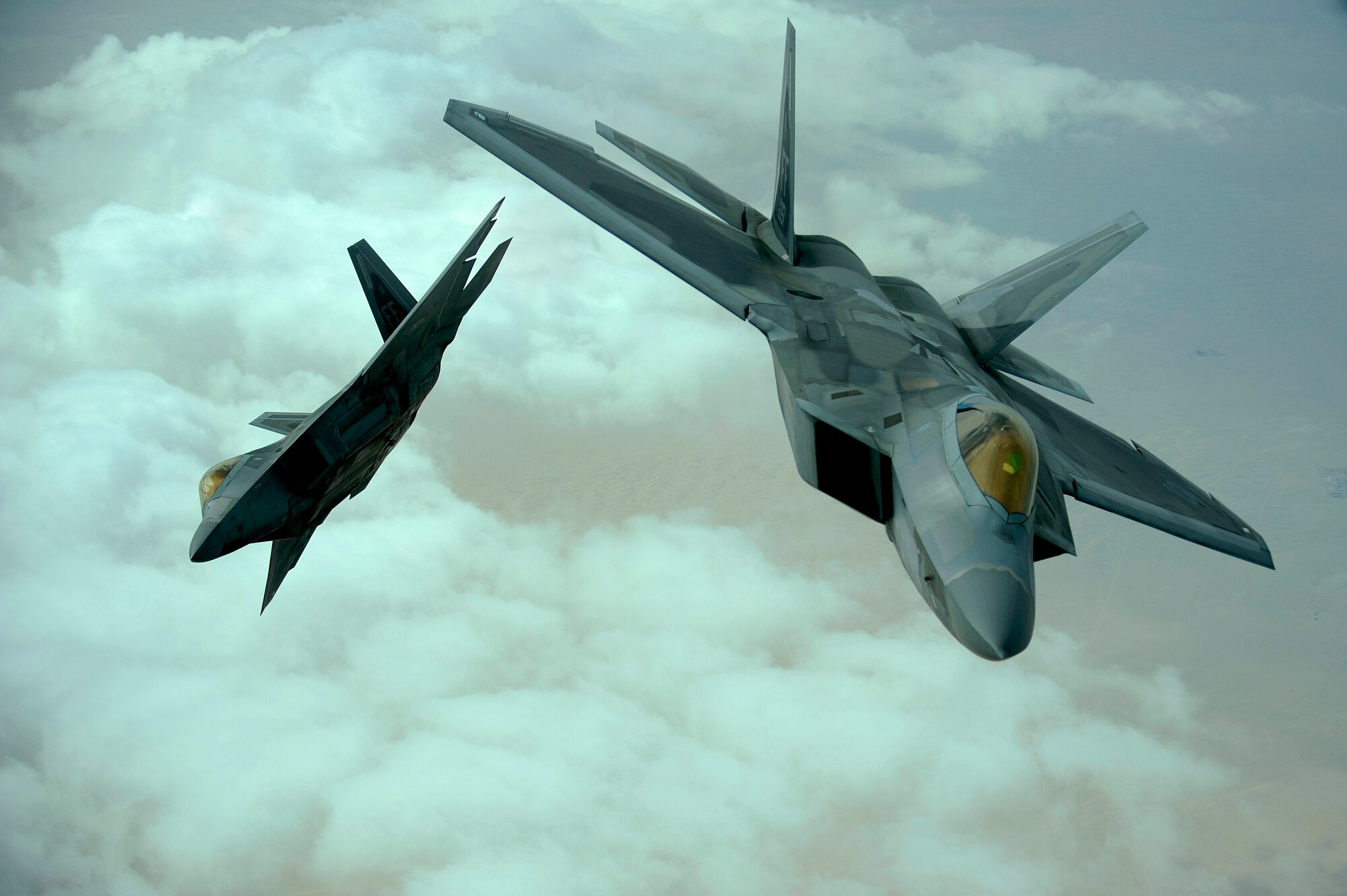 SOUTHWEST ASIA -- U.S. Air Force F-22 Raptors from the 27th Fighter Squadron at Langley Air Force Base, Va. fly in formation during a training mission, Dec. 6, 2009.  The F-22 fighters and crews  were deployed  to the Air Forces Central area of responsibility for the first time as part of a multi-national exercise where aircrews from France, Jordan, Pakistan, the United Arab Emerites., United Kingdom, and the United States trained together in fighting a large-scale air war.  (U.S. Air Force photo/Staff Sgt. Michael B. Keller)

