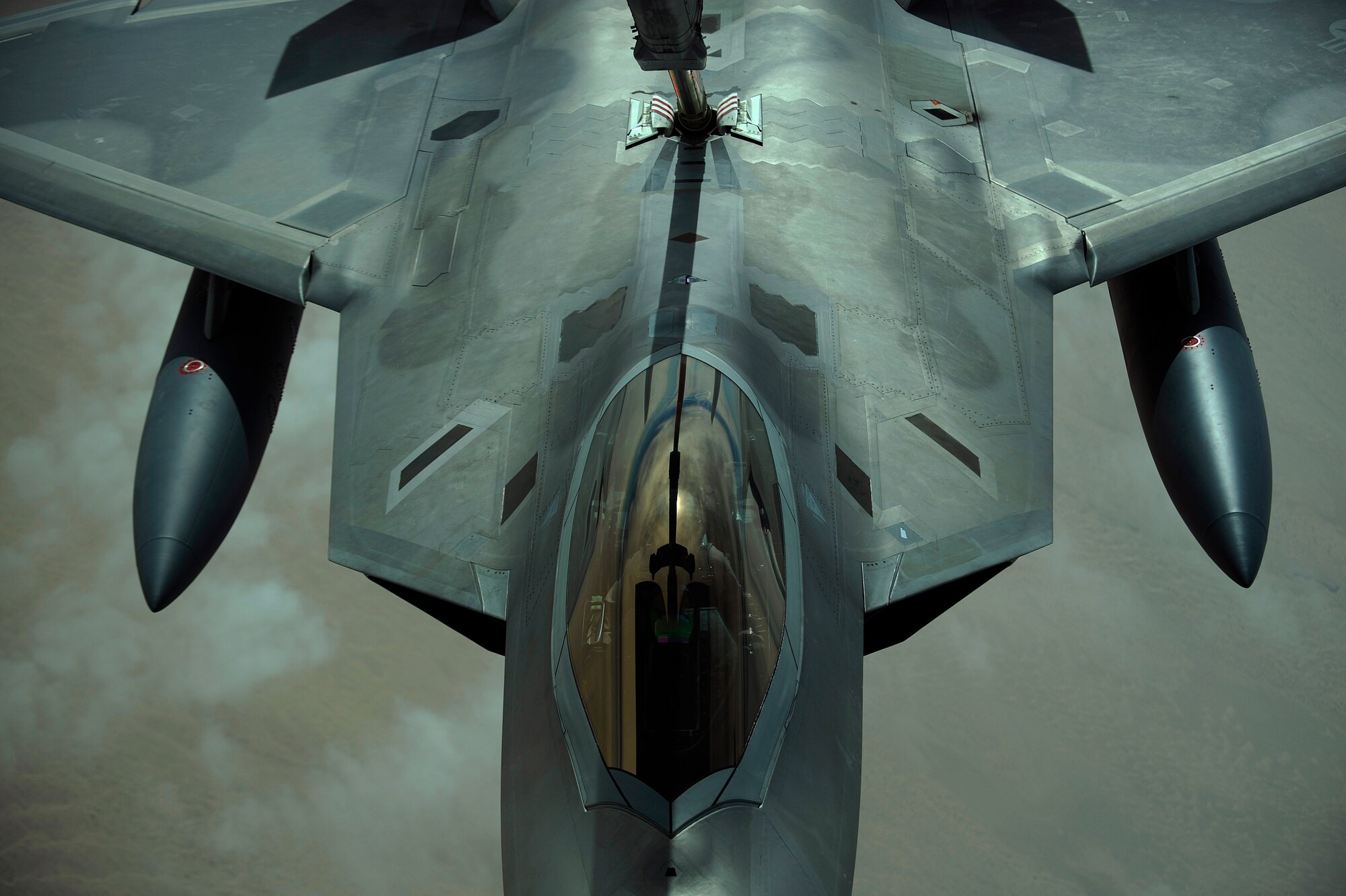 A U.S. Air Force F-22 Raptor is refueled by a 908th Expeditionary Air Refueling Squadron KC-10A Extender, Dec. 6, 2009.  The F-22 fighters and crews are deployed from the 27th Fighter Squadron at Langley Air Force Base, Va., and in the Air Forces Central area of responsibility for the first time as part of a multinational exercise where aircrews from France, Jordan, Pakistan, the U.A.E., the U.K., and the U.S. trained together in fighting a large-scale air war.  (U.S. Air Force photo by Staff Sgt. Michael B. Keller) (Released)
