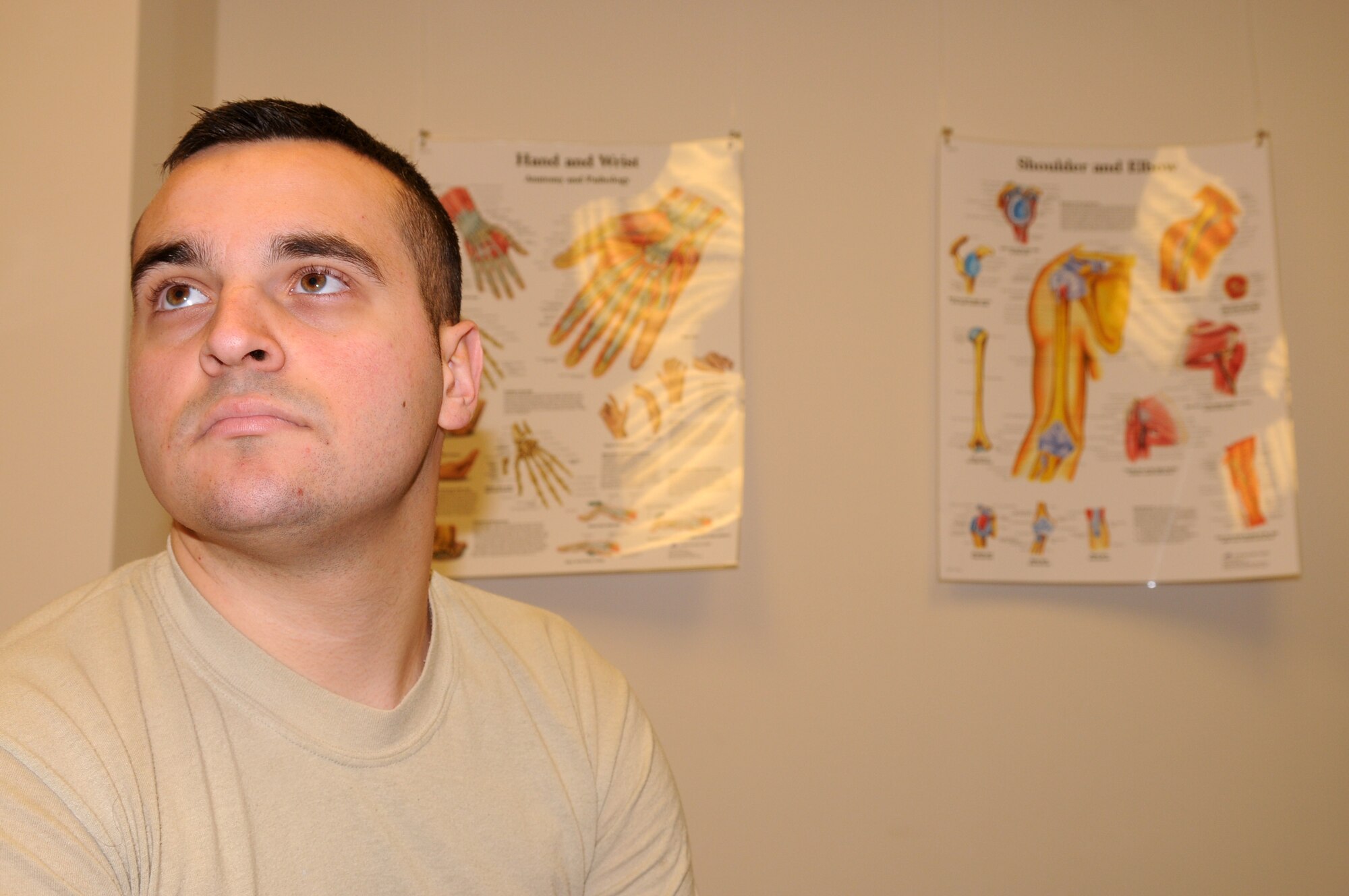 Senior Airman Michael Barclay, 31st Maintenance Squadron crew chief, studies the various injury charts posted in a patient room prior to his appointment, Dec. 19, 2009 at Aviano Air Base, Italy. Senior Airman Barclay recently sustained a dislocated collar bone during a snowboarding mishap while on a trip to Austria. The 31st Medical Group leaves surgery as a last resort for patients who cannot rehabilitate without help. Senior Airman Barclay is currently enrolled in a three times a week, eight week physical theory program to regain full pre-injury capabilities after which he will be re-evaluated to see if surgery is necessary.   
(U.S. Air Force photo/ Senior Airman Nadine Y. )
