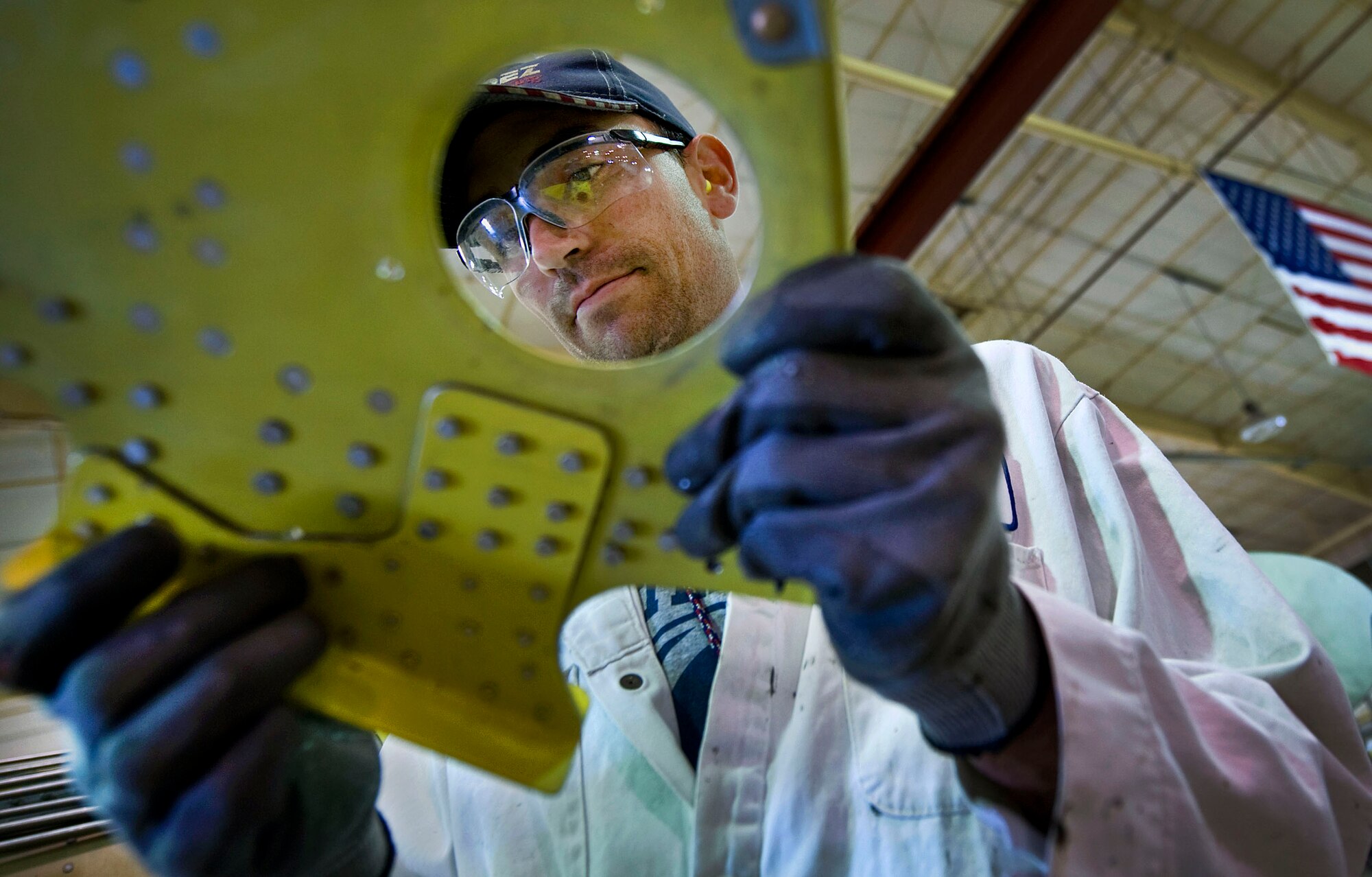 Eric Pedersen inspects a rib of an A-10 Thunderbolt II inner wing Dec. 17, 2009, after flattening the rivets. A-10s are undergoing a wing upgrade at the 309th Aerospace Maintenance and Regeneration Group at Davis-Monthan Air Force Base, Ariz.  The upgrade process, affectionately called the "Hog Up," will make the wings of the tank killer thicker and stronger while increasing the service life of the aircraft another 8,000 hours in the air.  Mr. Pederson is an aircraft structural mechanic at the 309th AMARG.  (U.S. Air Force photo/Staff Sgt. Bennie J. Davis III)