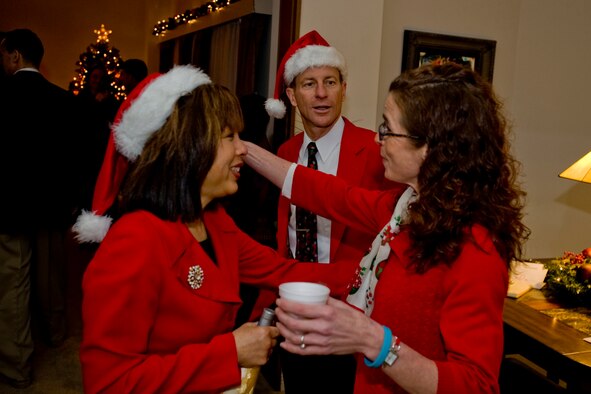 MISAWA AIR BASE, Japan -- Jan Stilwell, wife of Col. David Stilwell, 35th Fighter Wing commander, greets Janet Aanrud, wife of Lt. Col. Jay Aanrud, 13th Fighter Squadron commander, Dec. 18 during an open house at the Stilwell residence. The Stilwells treated guests to cookies and apple cider as the commander shared stories and welcomed base members to their home. (U.S. Air Force photo/Senior Airman Jamal D. Sutter)