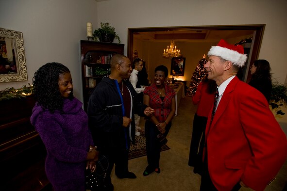 MISAWA AIR BASE, Japan -- Chief Master Sgt. McHudson Theodore, 35th Civil Engineer Squadron fire chief, and his family share a laugh with Col. David Stilwell, 35th Fighter Wing commander, Dec. 18 during an open house at the Stilwell residence. The open house granted guests a chance to bond with the Stilwell family and better know their commander on a personal level. (U.S. Air Force photo/Senior Airman Jamal D. Sutter)