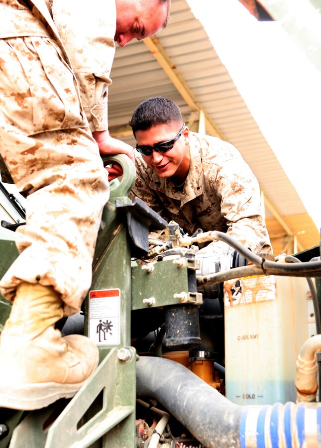 Reserve Marine 1st Lt. Pierre Zapata-Rivera, the transportation company executive officer with Combat Logistics Battalion 46, inspects a vehicle with a fellow Marine here Dec. 21, 2009.   Zapata-Rivera, who hails from Queens, N.Y., was commissioned through the Officer Candidate Course, Reserve in November 2007.  ::r::::n::Official USMC photo by