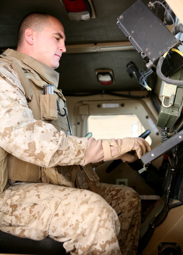 First Lt. Jonathan Babineau, 4th platoon commander for Transportation Company, Combat Logistics Battalion 46, checks the blue force tracker in a Mine Resistant Ambush Protected vehicle here Dec. 21, 2009.   Babineau, 27, of Worcester, Mass., went through a Marine Reserve officer commissioning program in 2007.  He has been running combat logistics patrols  on the Iraq-Jordanian border for the past several months.