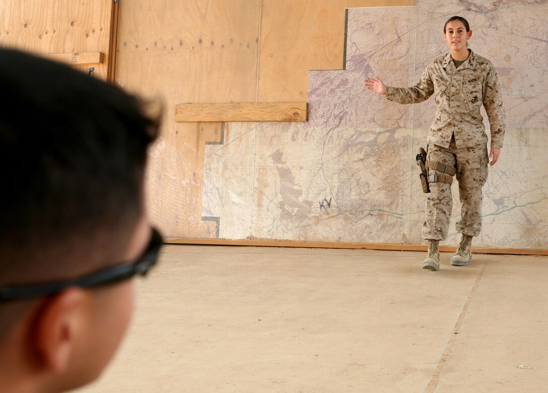 Reserve Marine 1st Lt. Sarah Feinberg, assistant battalion operations officer for Combat Logistics Battalion 46, instructs a class of Marines in convoy brief procedures here Dec. 21, 2009.  Feinberg graduated from Marine Corps Officer Candidate School in November 2007.  She deployed to Iraq in 2009 and has commanded numerous resupply missions in western Al Anbar Province over the past several months.