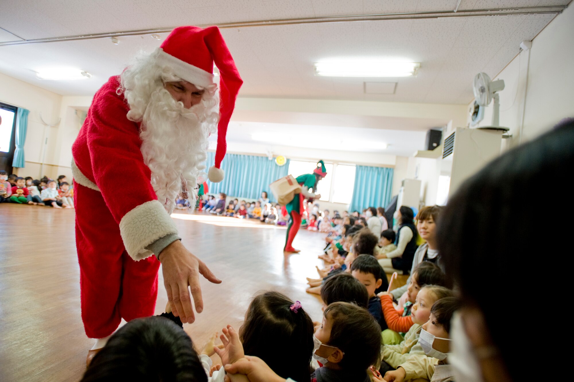 MISAWA CITY, Japan -- Dressed as Santa Claus, Senior Master Sgt. John Mazza, 35th Civil Engineer Squadron superintendant, greets children Dec. 21 during his visit to the Misawa Municipal Chuo Child-Care Center. The children got a chance to ask Santa questions and take photos with him and his helpers. (U.S. Air Force photo/Senior Airman Jamal D. Sutter)
