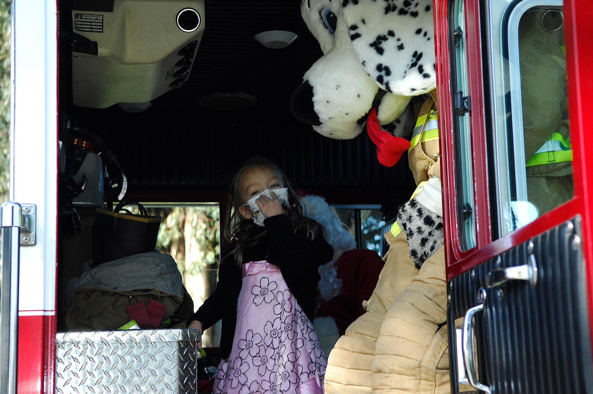 VANDENBERG AIR FORCE BASE, Calif. -- Getting ready to make her grand entrance at the assembly, Makaila Lubas, daughter of Senior Master Sgt. Frank Lubas, boards a Vandenberg fire truck here Friday, Dec. 18, 2009, with Spot the Fire Dog and Santa. After learning of Makaila's diagnosis of leukemia, the students at Crestview Elementary School raised more than $1,600 during the fundraiser deemed "Pennies for Makaila" and presented her a check during the assembly. (U.S. Air Force photo/Airman 1st Class Heather R. Shaw)