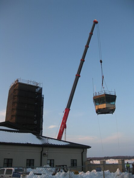 Base contractors remove the old air traffic control tower at Dover Air Force Base Dec. 22. The tower was constructed in 1955 and was replaced with a new new air traffic control tower Oct. 26. The new tower features upgraded equipment and will help to increase the overall safety of flight operations at Dover. (U.S. Air Force photo/Joan Cote)                           