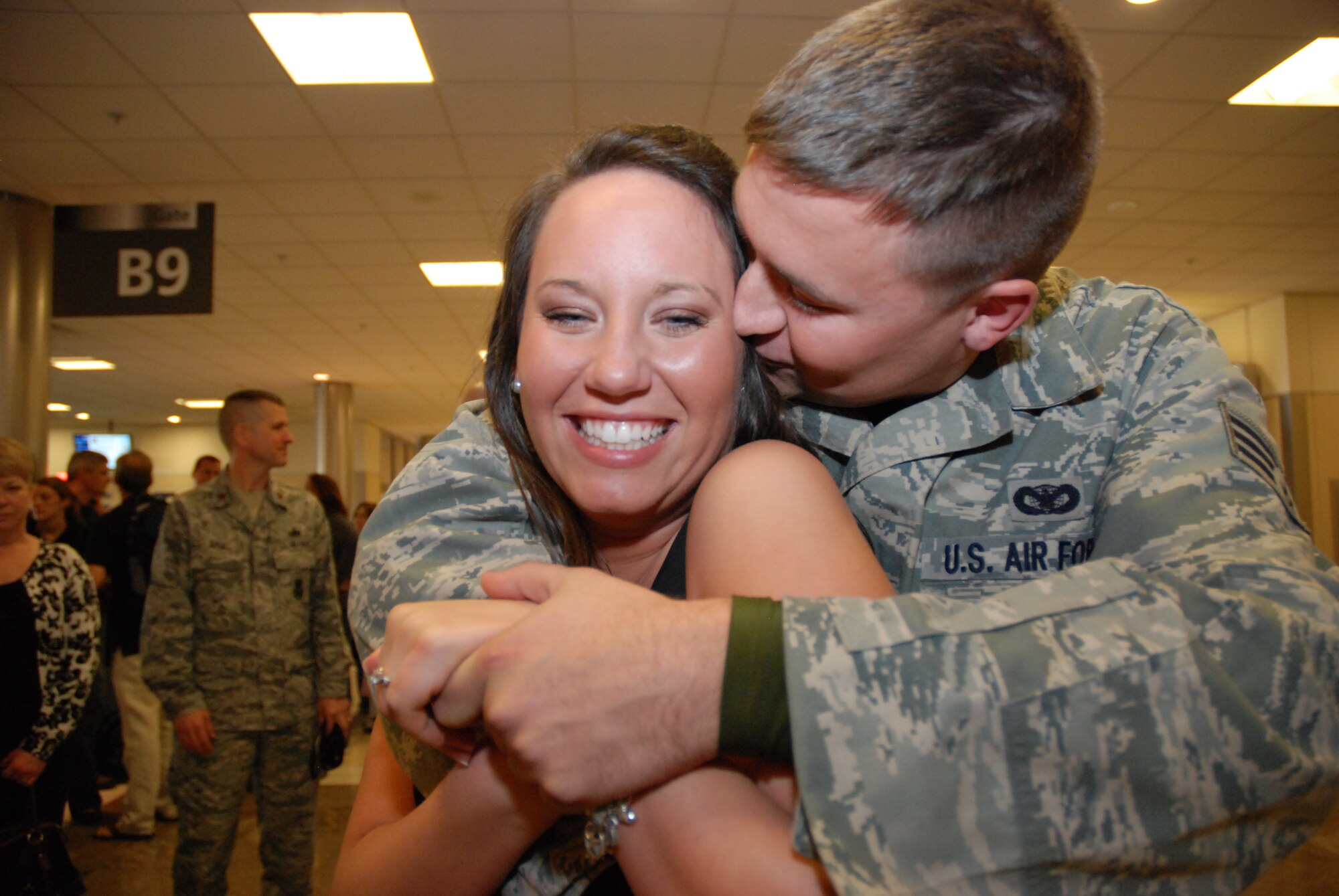 Senior Airman Russell Kuhlman, 94th Security Forces Squadron member, surprises girlfriend, McCalla Aragon, with a proposal at the Atlanta Hartsfield-Jackson Airport Jan. 5. Airman Kuhlman and other members of 94th SFS returned home after a six-month deployment to southwest Asia. (U.S. Air Force photo/Master Sgt. Stan Coleman)