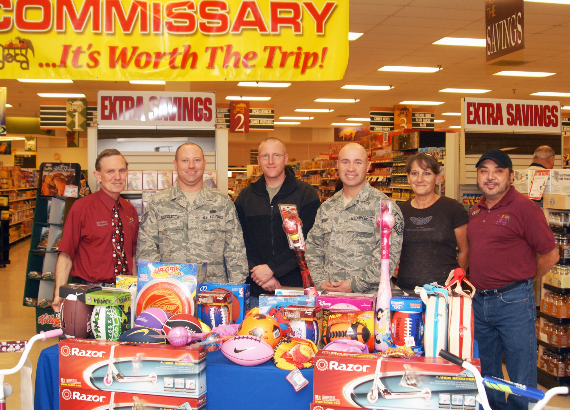 Don Rouse, Goodfellow Commissary store director; Tech. Sgt. Jason Suffoletta and Tech. Sgt. Joseph Stagner both 17th Communications Squadron acting first sergeants; Master Sgt. Michael Miller, 17th Medical Group first sergeant; Claire Cook, Continental/Unilever Service representative and John Gongora, Goodfellow Commissary general grocery manager, stand with donated toys accepted by the Goodfellow First Sergeant's Warmheart project at the commissary on Goodfellow AFB, Texas, Dec. 21.  The commissary competed in a Defense Commissary Agency wide fitness and health program with other commissaries sponsored by vendors who donated the toys.  Warmheart contributes food and food vouchers as well as toys to deserving families.  (U.S. Air Force photo/Robert D. Martinez)