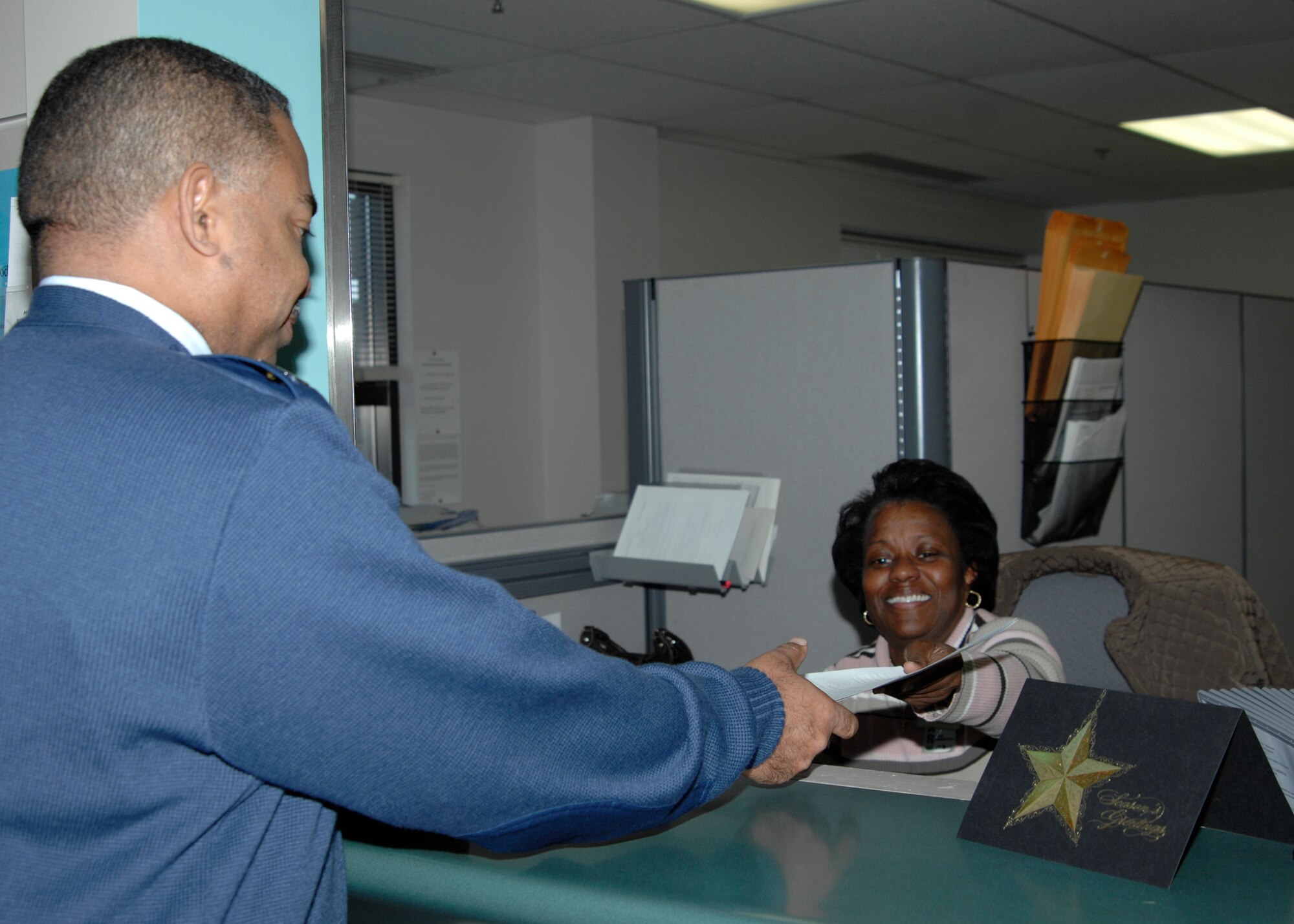 Chief Master Sgt. Kevin Brooks, 22nd Maintenance Squadron, books an appointment with Carmen Jones, a 22nd Aero-Medical Dental Squadron dental assistant, Dec. 14, 2009, at McConnell Air Force Base, Kan. Mrs. Jones has been at McConnell for almost 15 years. (U.S. Air Force Photo by Airman 1st Class Justin Shelton)