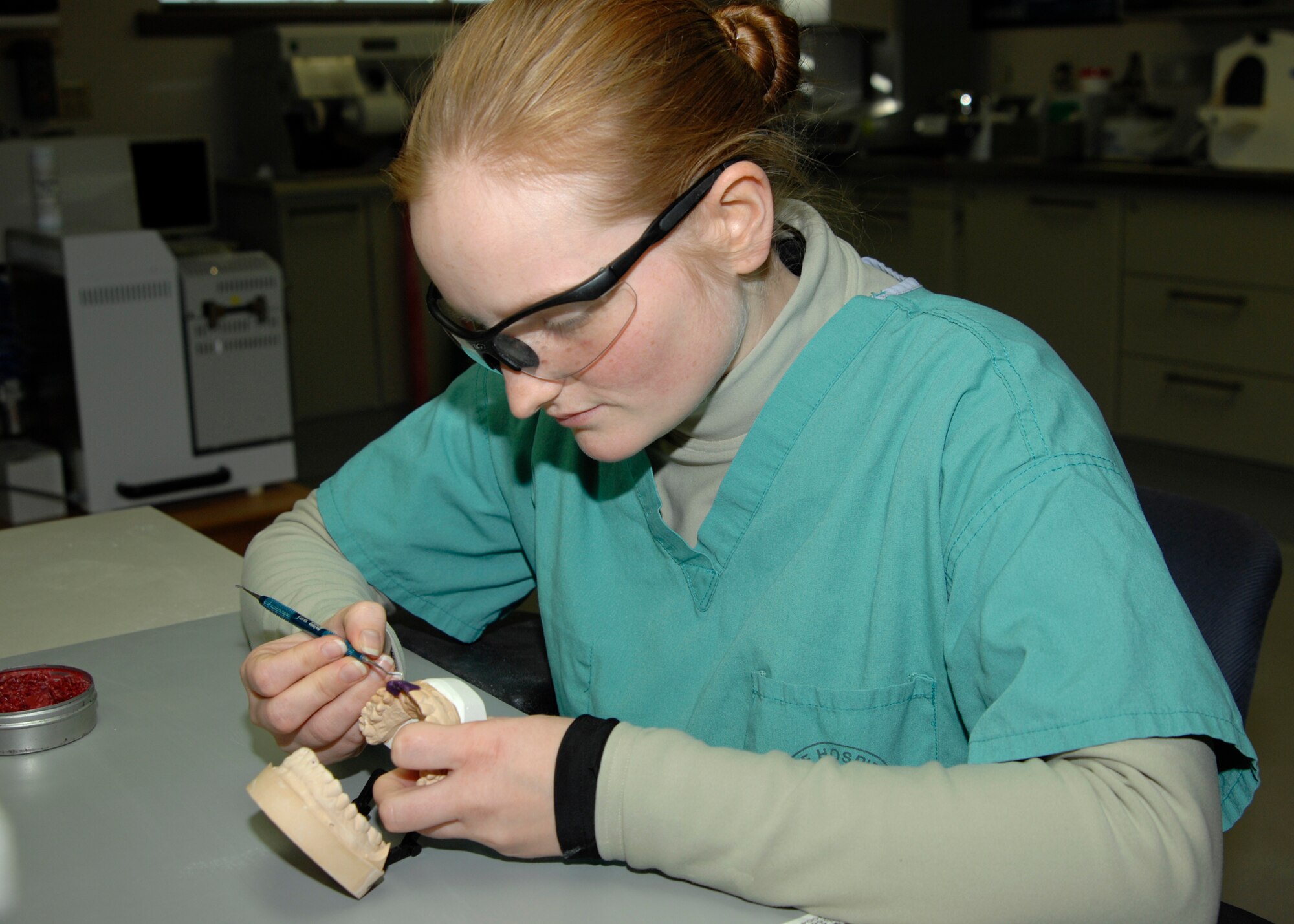 Airman 1st Class Grace Laughlin, prepares a mold for a dental crown, Dec. 14, 2009 at the McConnell Air Force Base, Kan. clinic.  Airman Laughlin is a dental lab technician and produces bridges, crowns, and other dental augmentations for patients.  (U.S. Air Force Photo by Airman 1st Class Justin Shelton)