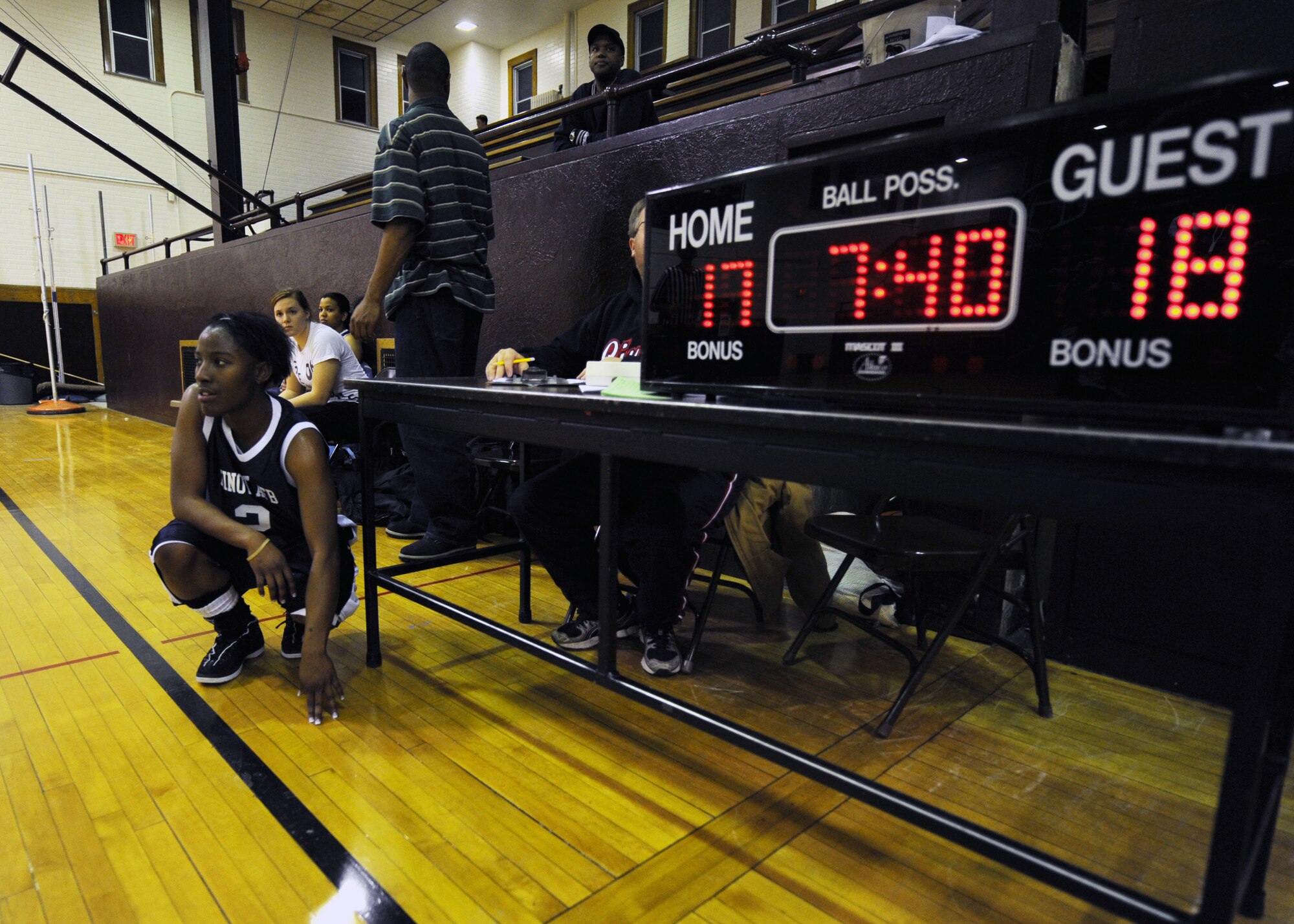 MINOT, N.D. -- Airman 1st Class Sosha Bradford, 5th Maintenance Squadron aircrew ground equipment journeyman, waits to substitute in during the Minot AFB Lady Magic’s basketball game against Fort Berthold Community College at Minot High Central Campus Dec. 16. The Lady Magic defeated FBCC 52-47. (U.S Air Force photo by Senior Airman Sharida Jackson)