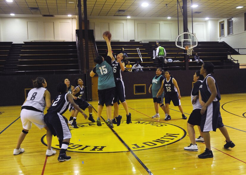 MINOT, N.D. -- Senior Airman Kimberley Lane, 5th Munitions Squadron convenetional maintenance crew member, jumps for the ball at tip-off during the Minot AFB Lady Magic’s basketball game against Fort Berthold Community College at Minot High Central Campus Dec. 16. The Lady Magic defeated FBCC 52-47. (U.S Air Force photo by Senior Airman Sharida Jackson)
